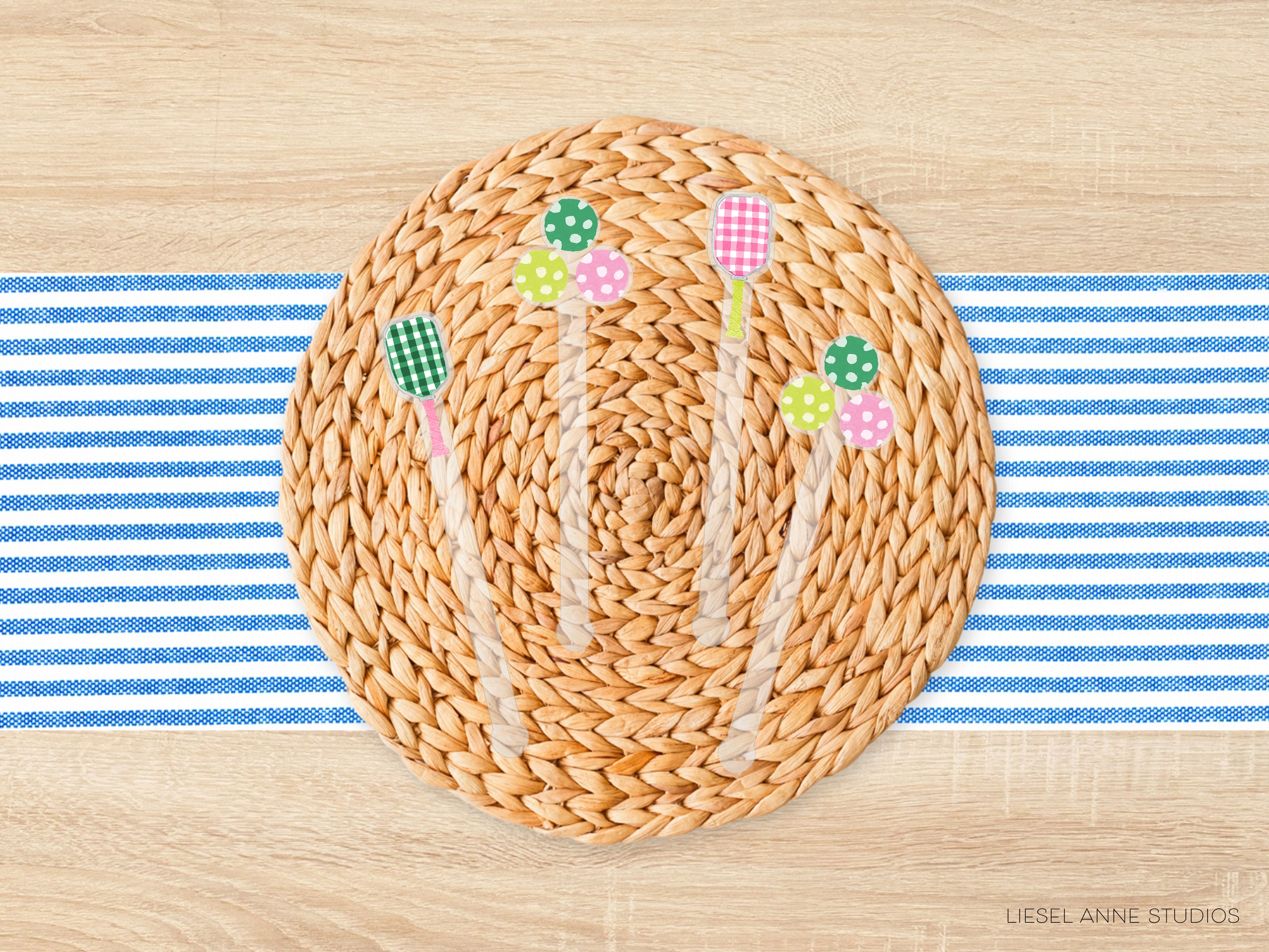 A woven placemat with colorful polka dot and green polka dot decorations placed on a blue and white striped tablecloth.