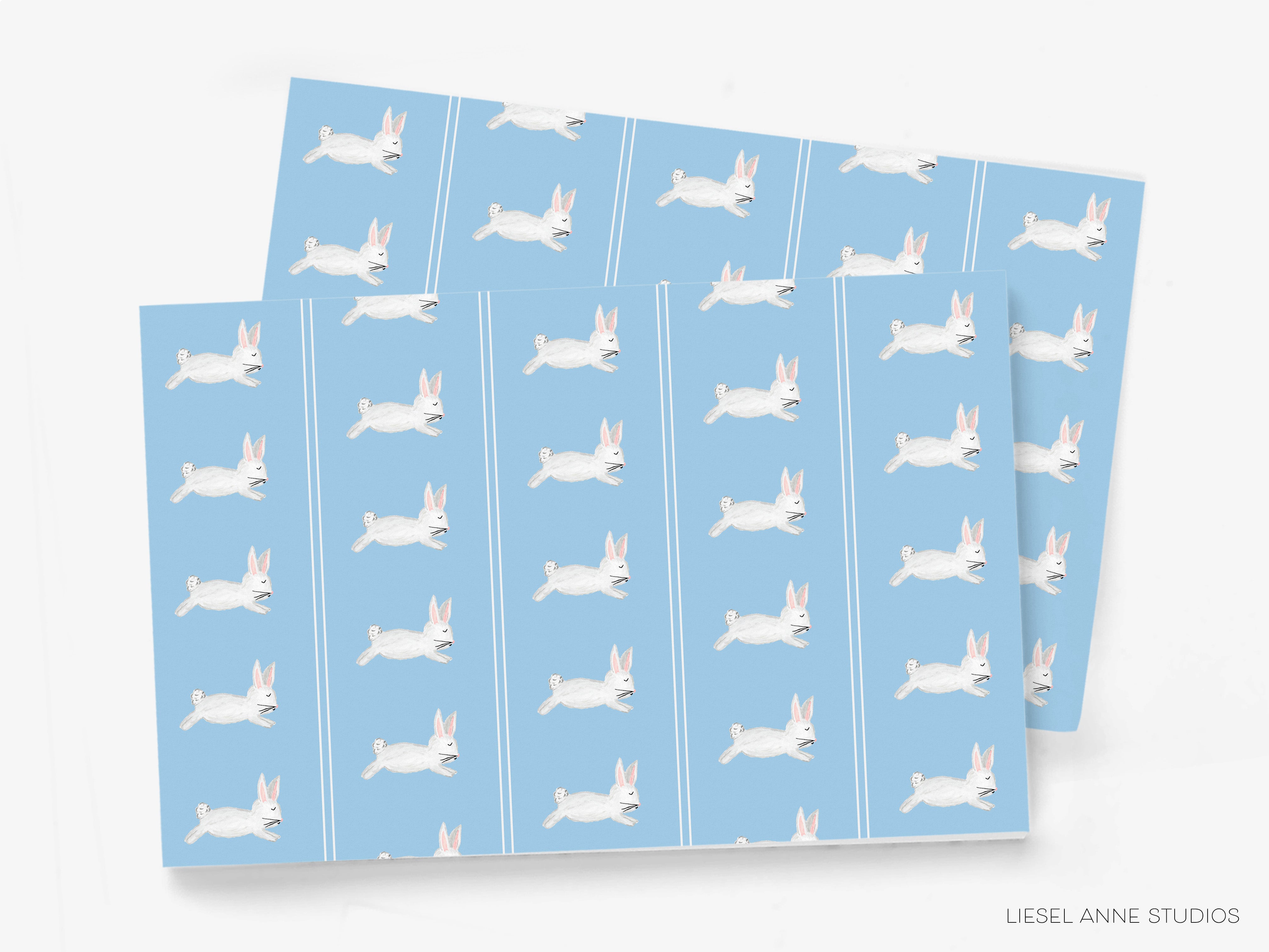 a repeating pattern of white rabbits against a light blue background.