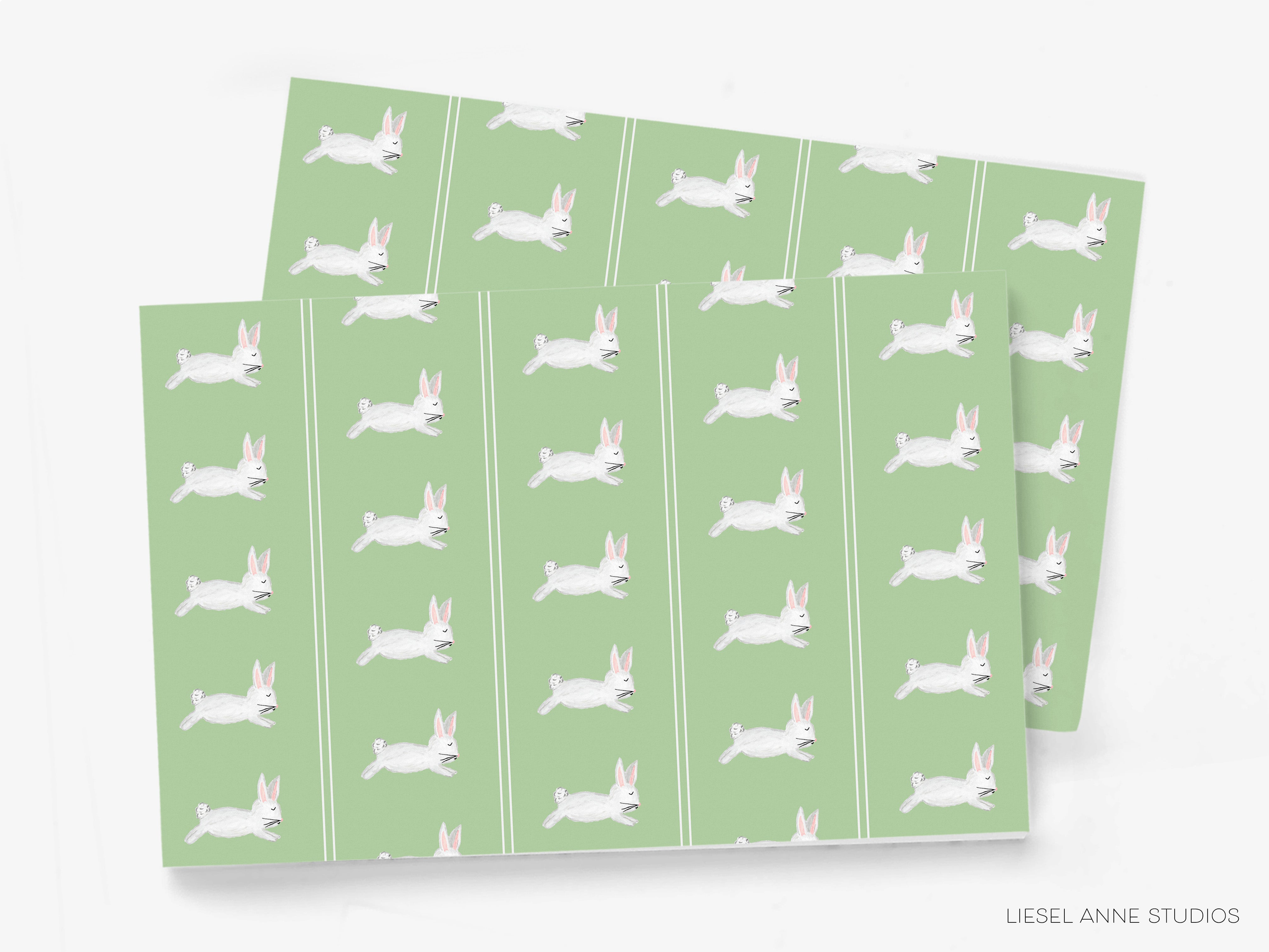 a repeating pattern of white rabbits on a green background.