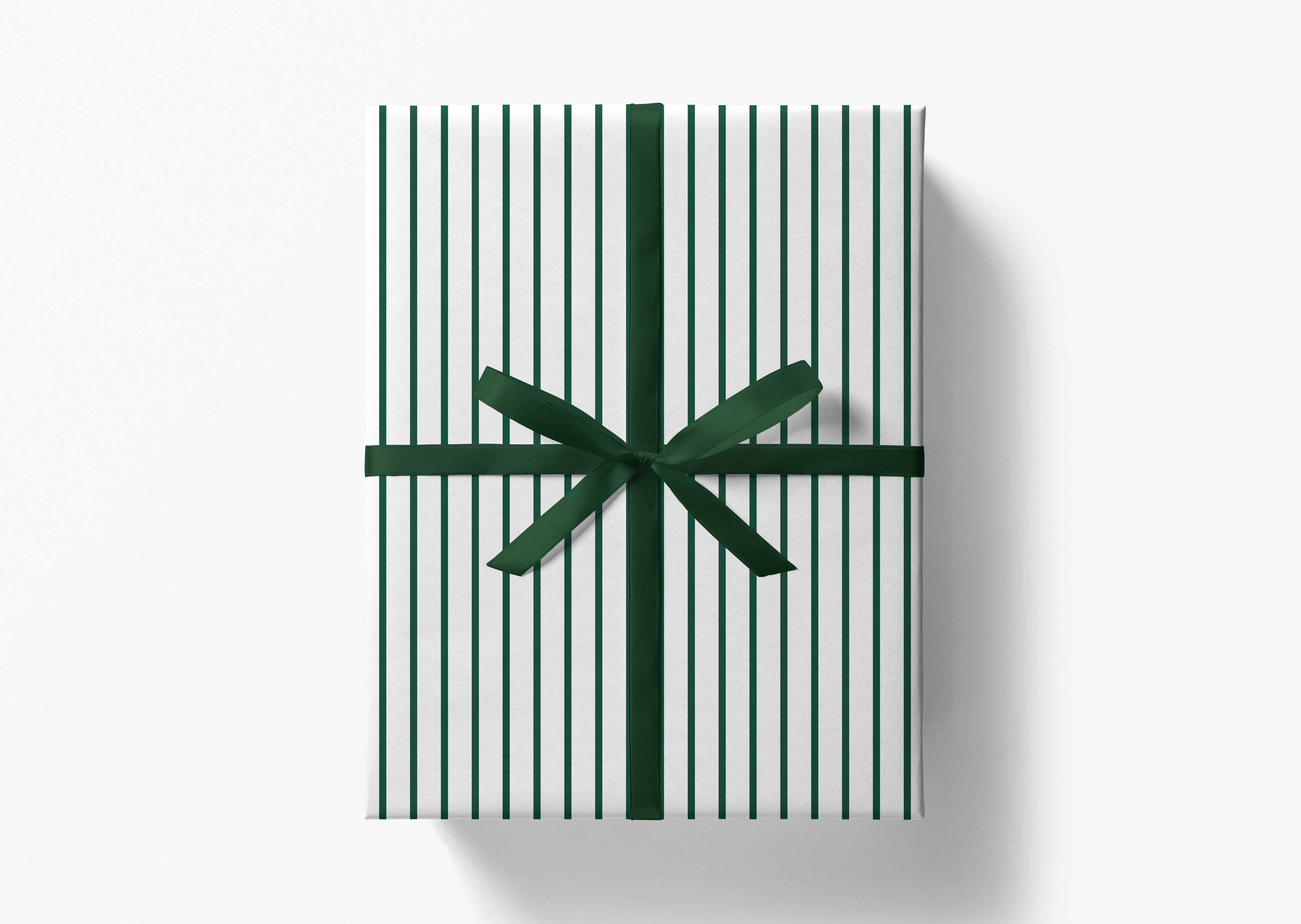 A gift box wrapped in white paper with green stripes and tied with a green ribbon bow.