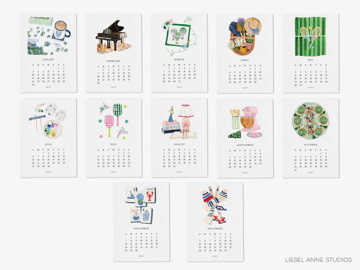 All twelve months of the Happy Hobbies 2027 watercolor desk calendar: puzzles, music, needlepoint, gardening, tennis, painting, pickleball, reading, baking, hosting, mahjong and skiing