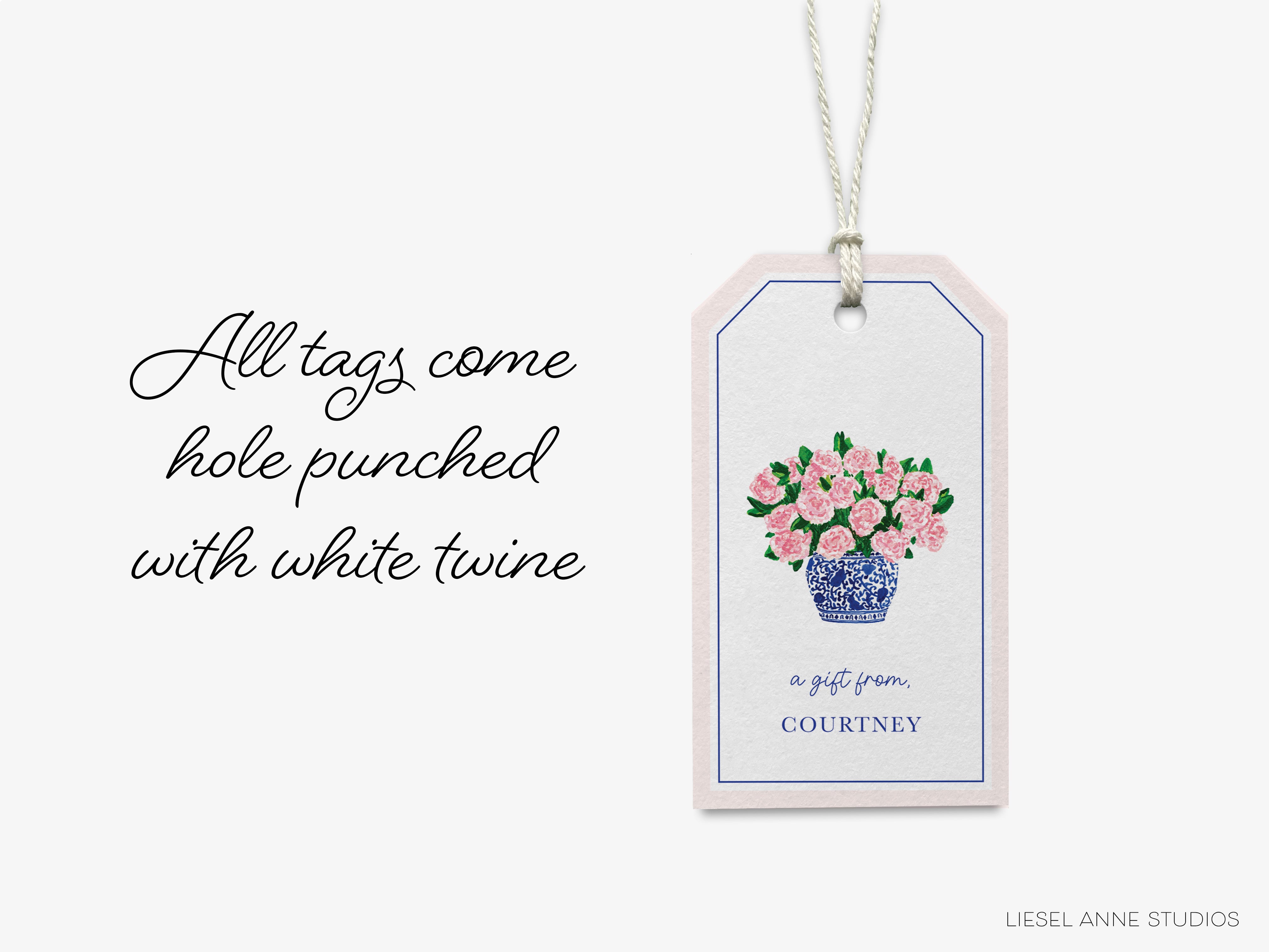 a white tag with pink flowers on it