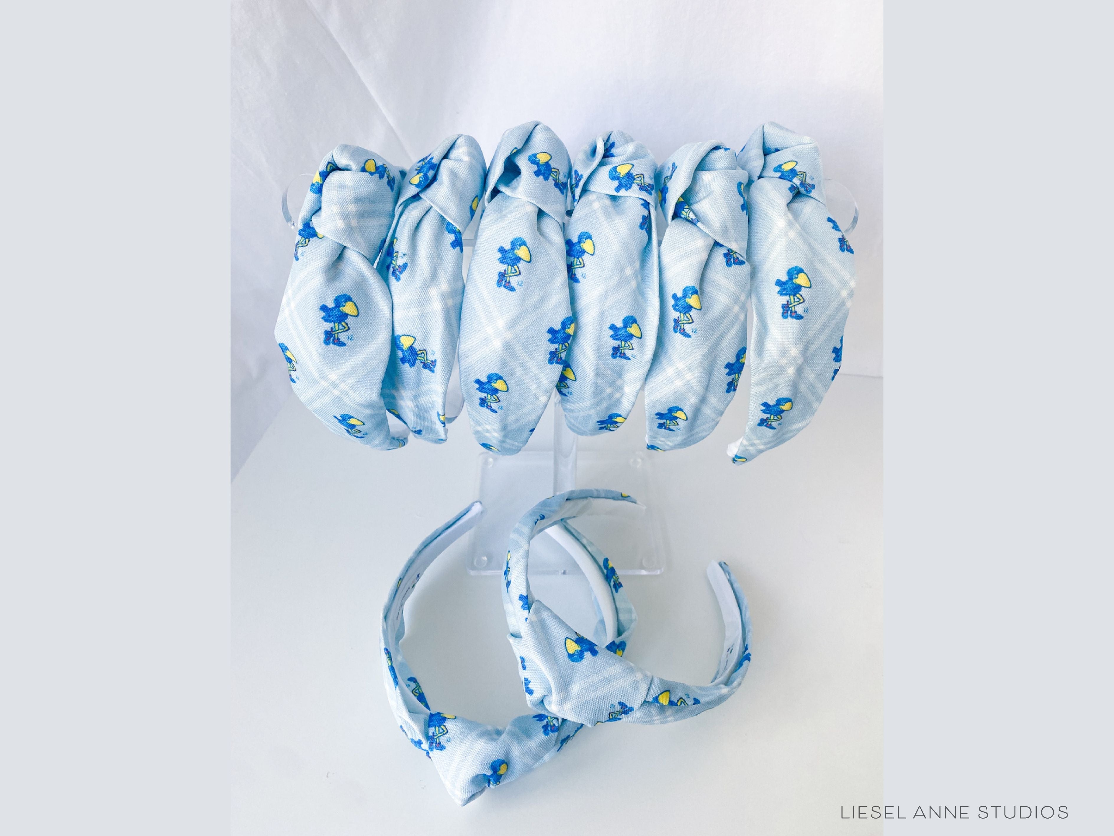 1912 Jayhawk Officially Licensed Light Blue Diamond Headband-These fabric headbands make unique one-of-a-kind gifts as each one is slightly different. They are cut from our hand-painted signature print. These are the perfect accessory and make great gifts!-The Singing Little Bird