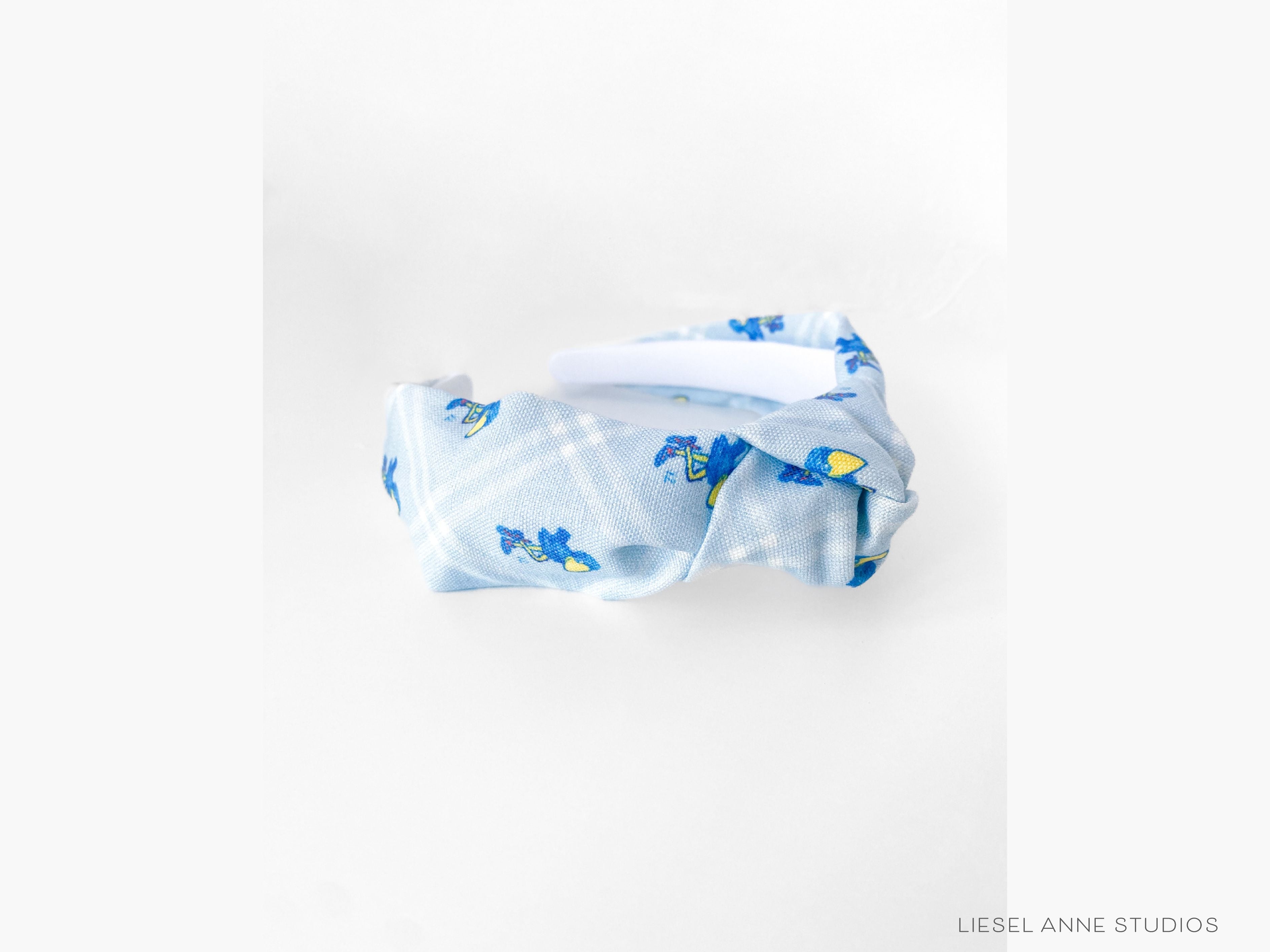 1912 Jayhawk Officially Licensed Light Blue Diamond Headband-These fabric headbands make unique one-of-a-kind gifts as each one is slightly different. They are cut from our hand-painted signature print. These are the perfect accessory and make great gifts!-The Singing Little Bird