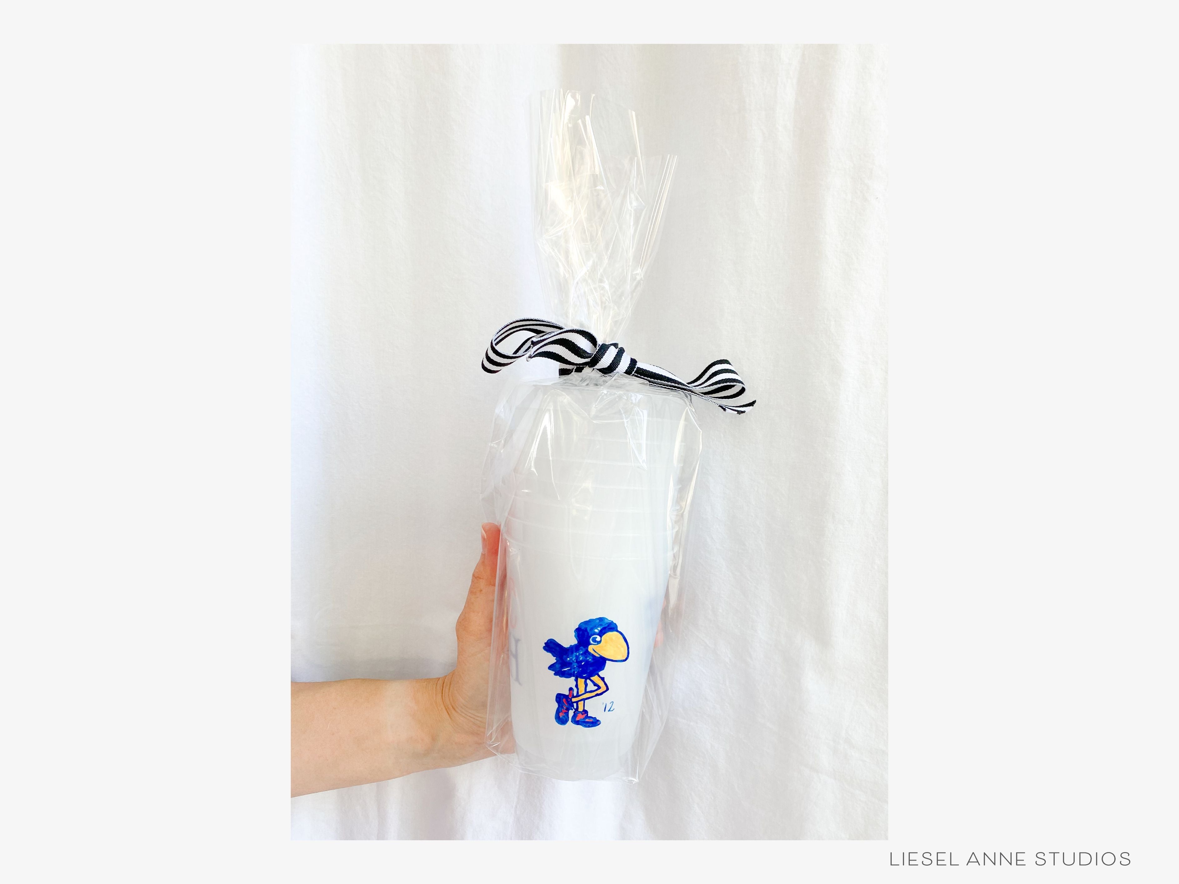 1912 Jayhawk *Officially Licensed* RCJH 16oz Shatterproof Cups (Set of 8)-These officially licensed Kansas Jayhawk shatterproof cups feature our hand-painted 1912 Jayhawk and make great party decorations for watch parties, graduation, game days and more! They come in sets of 8 and are re-usable for other parties to come or make wonderful party favors!-The Singing Little Bird