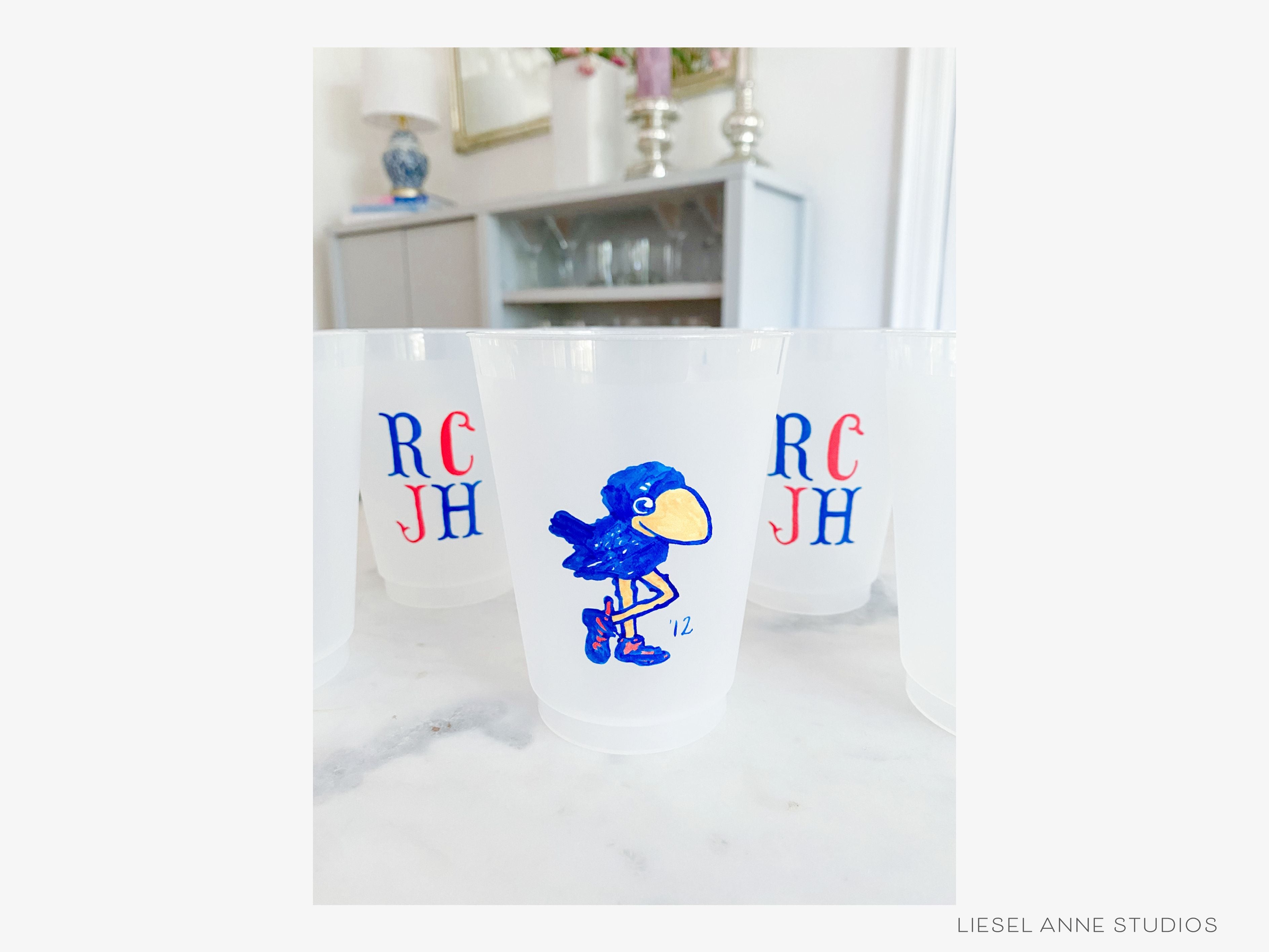 1912 Jayhawk *Officially Licensed* RCJH 16oz Shatterproof Cups (Set of 8)-These officially licensed Kansas Jayhawk shatterproof cups feature our hand-painted 1912 Jayhawk and make great party decorations for watch parties, graduation, game days and more! They come in sets of 8 and are re-usable for other parties to come or make wonderful party favors!-The Singing Little Bird