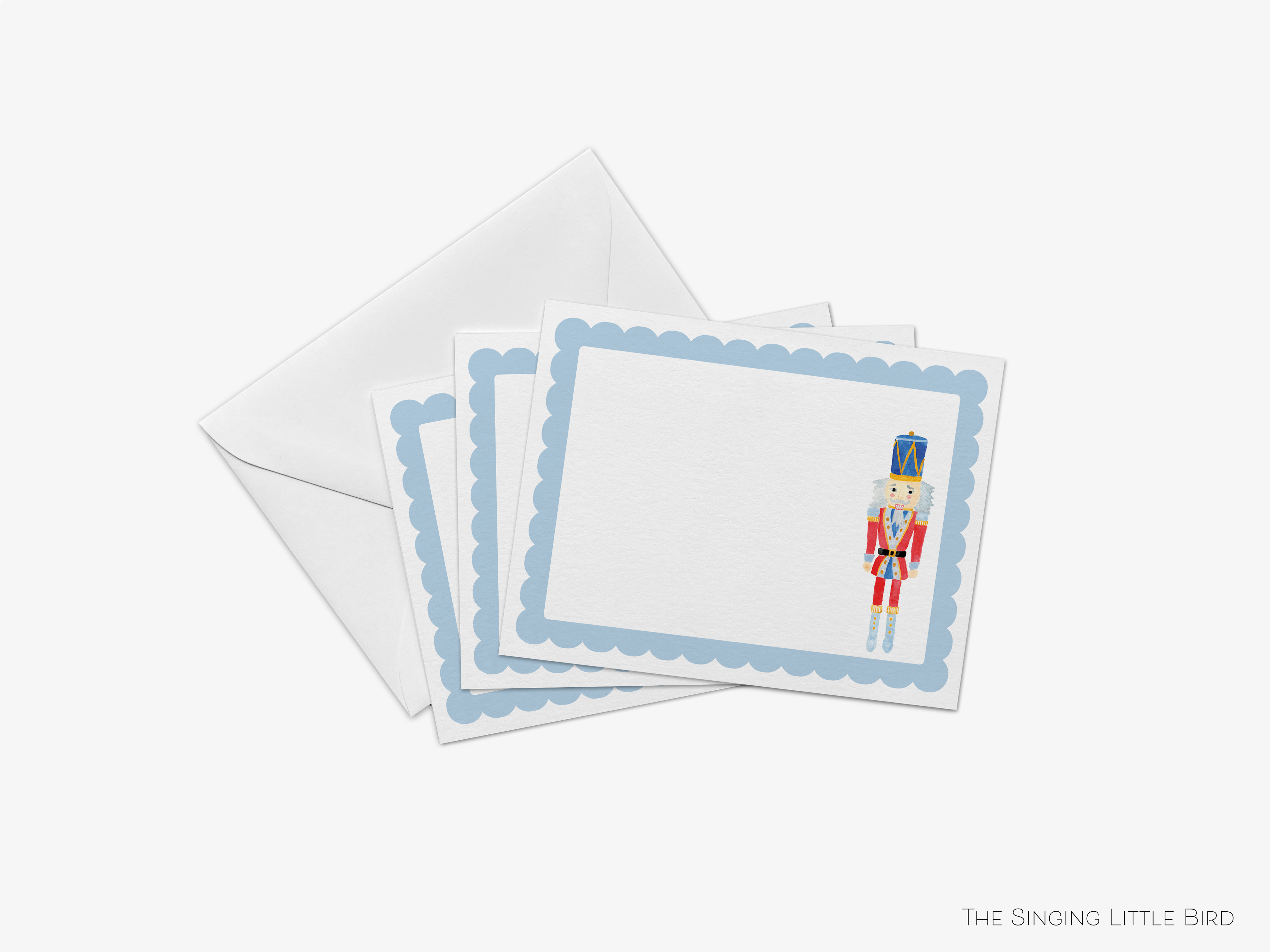 a set of greeting cards with a nutcracker design on the front, placed on top of an envelope.