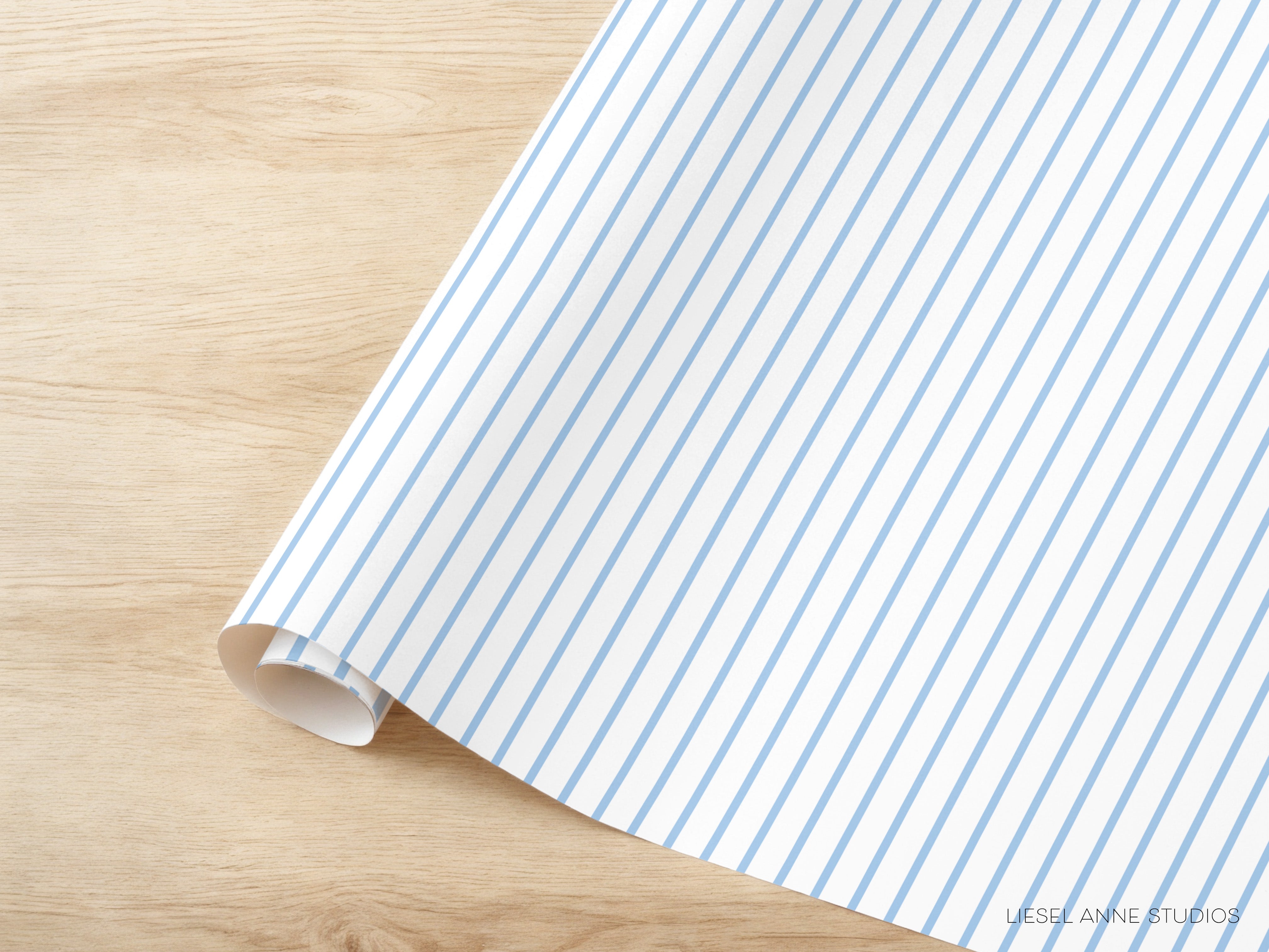 A roll of blue and white striped paper is placed on a wooden surface.