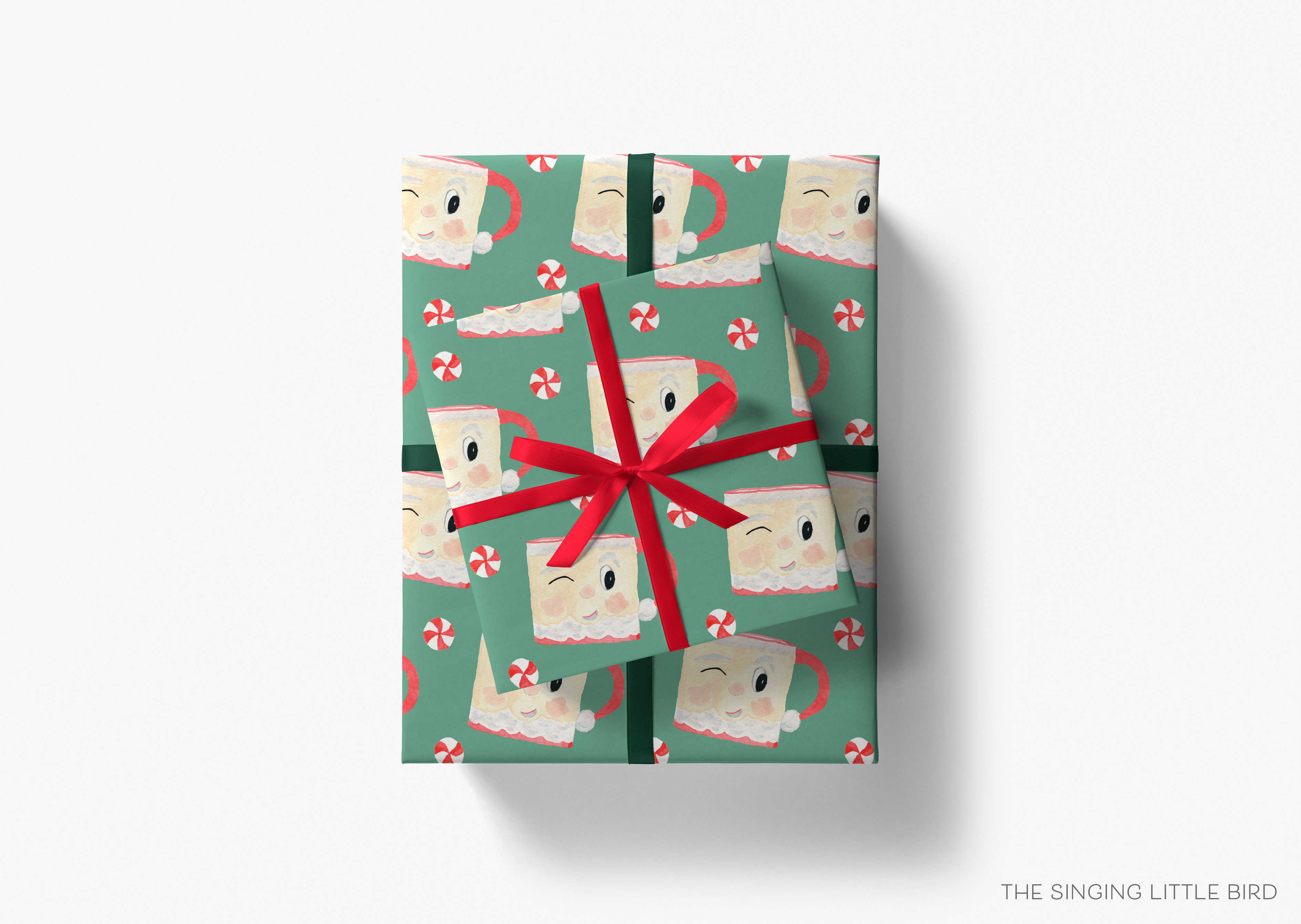 A gift box with a pattern of Santa Claus and candy canes on a green background, tied with a red ribbon.