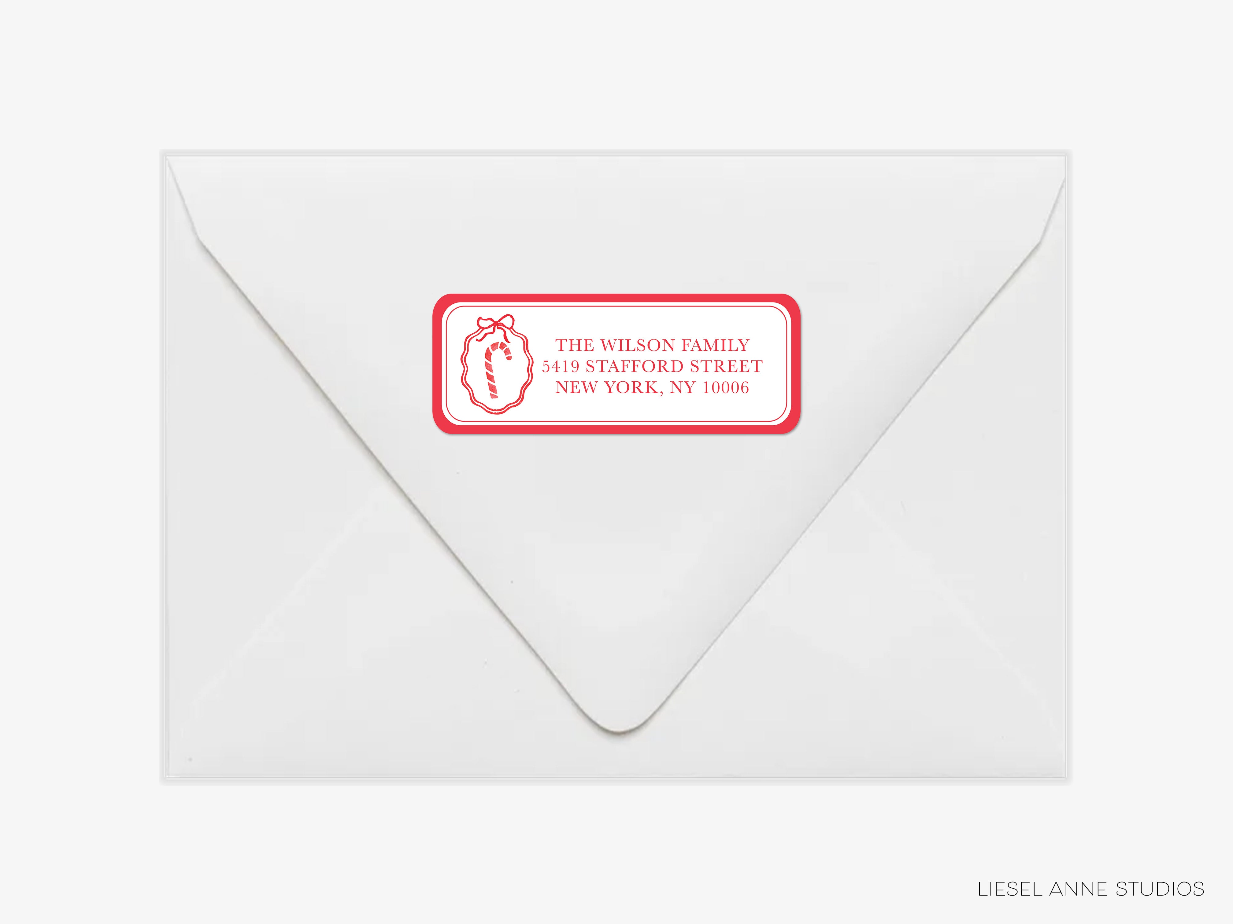 a white envelope with a red and white label on it, which appears to be a personalized address label.