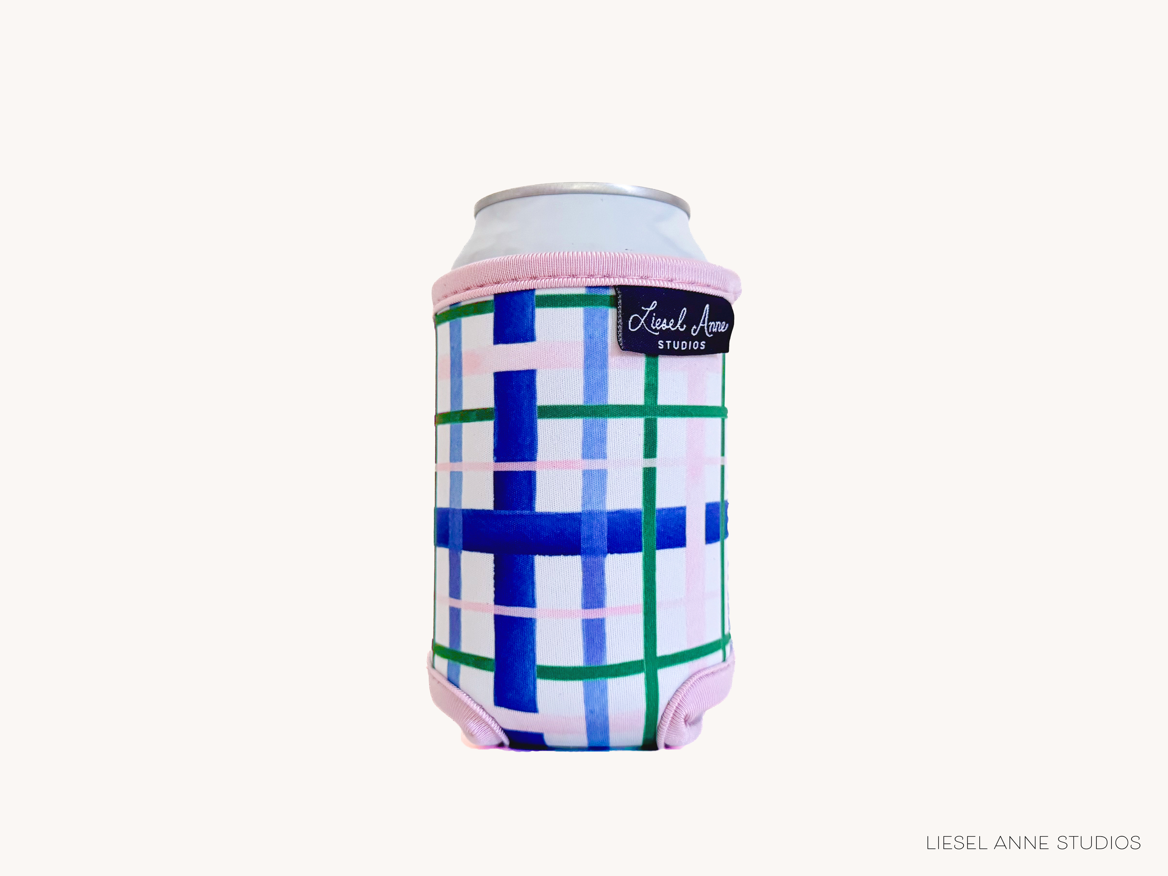 A colorful, patterned can holder with a pink and blue design, featuring a can of soda.
