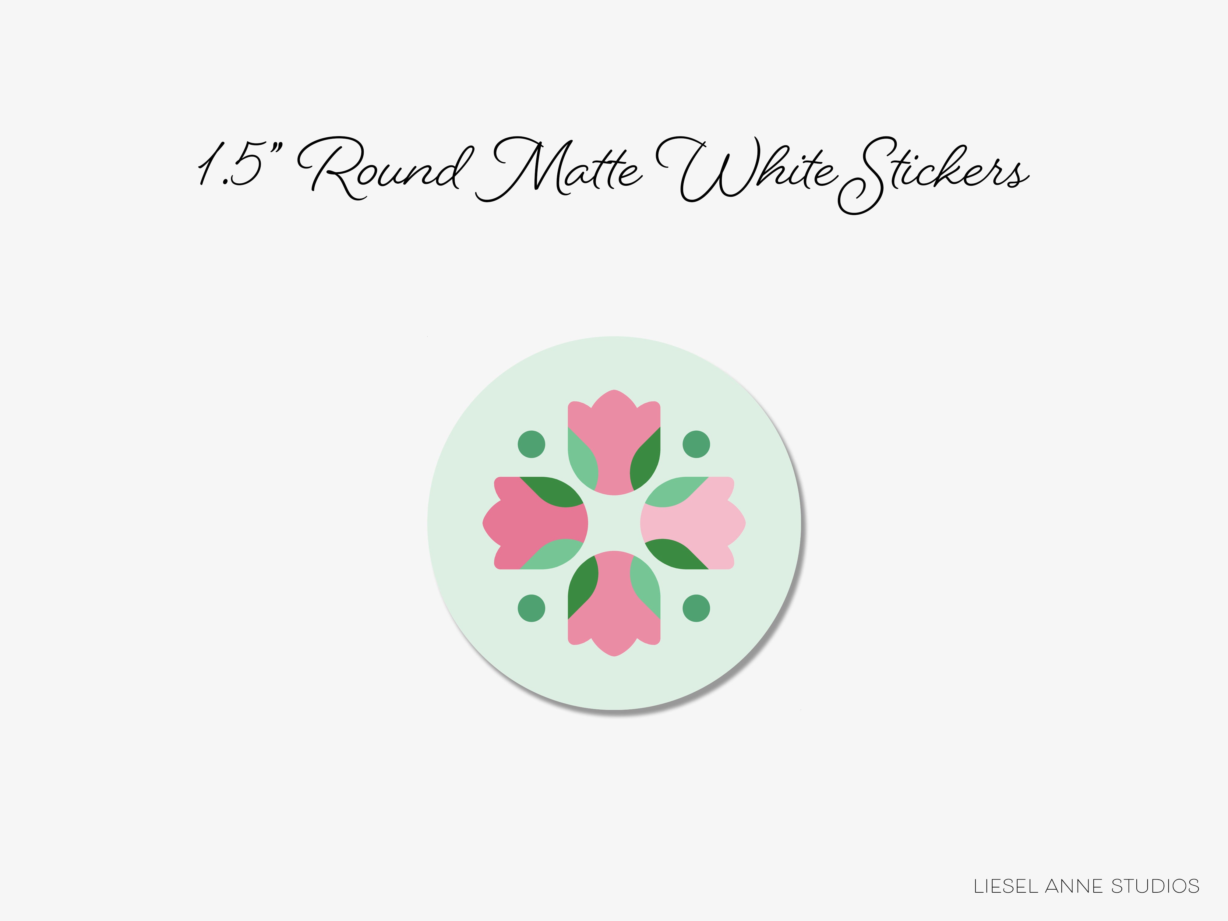 a round sticker with a floral design and green leaves.
