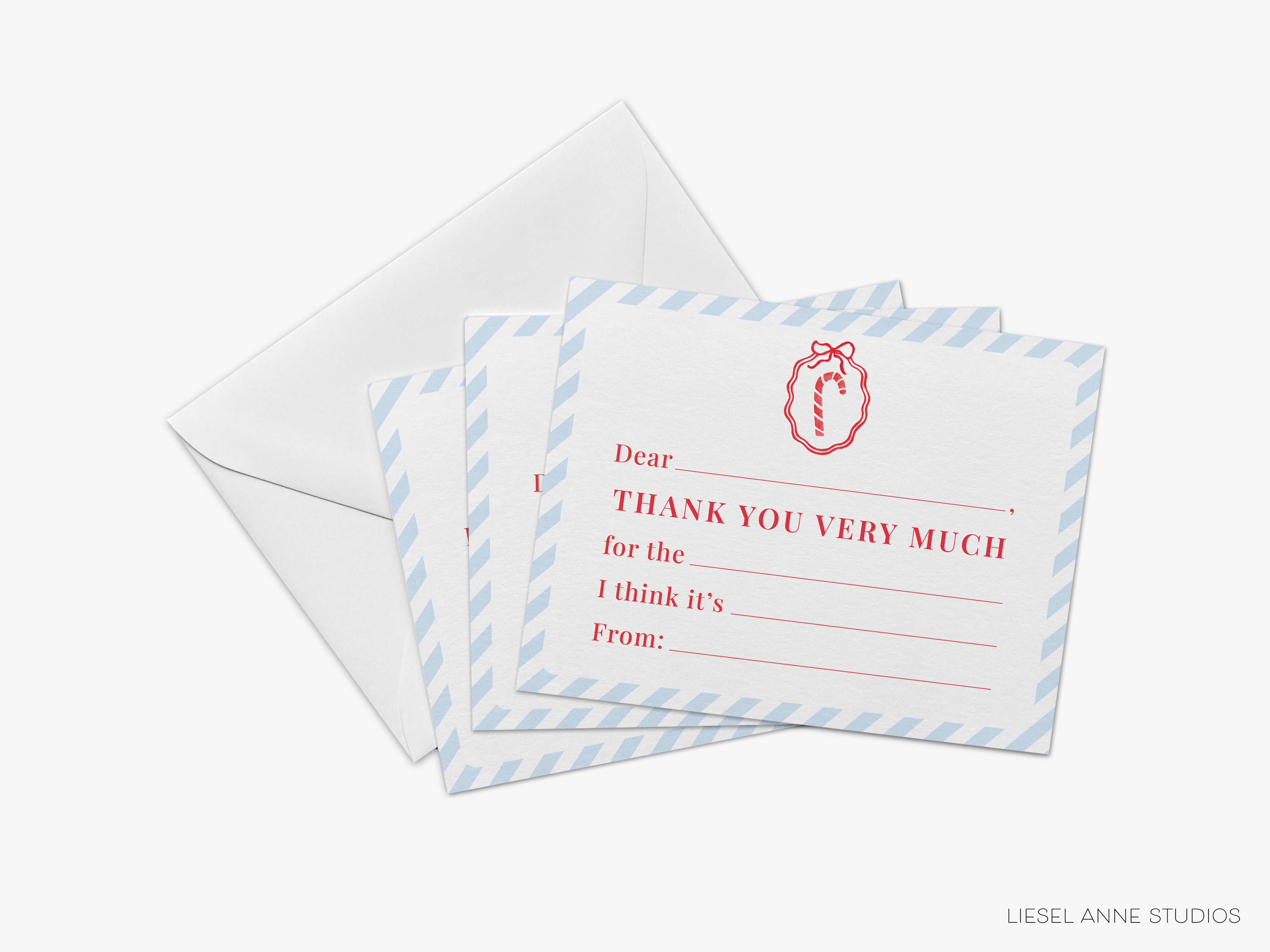 a set of blue and white striped envelopes with a red and white design on them, along with a note card inside one of the envelopes.