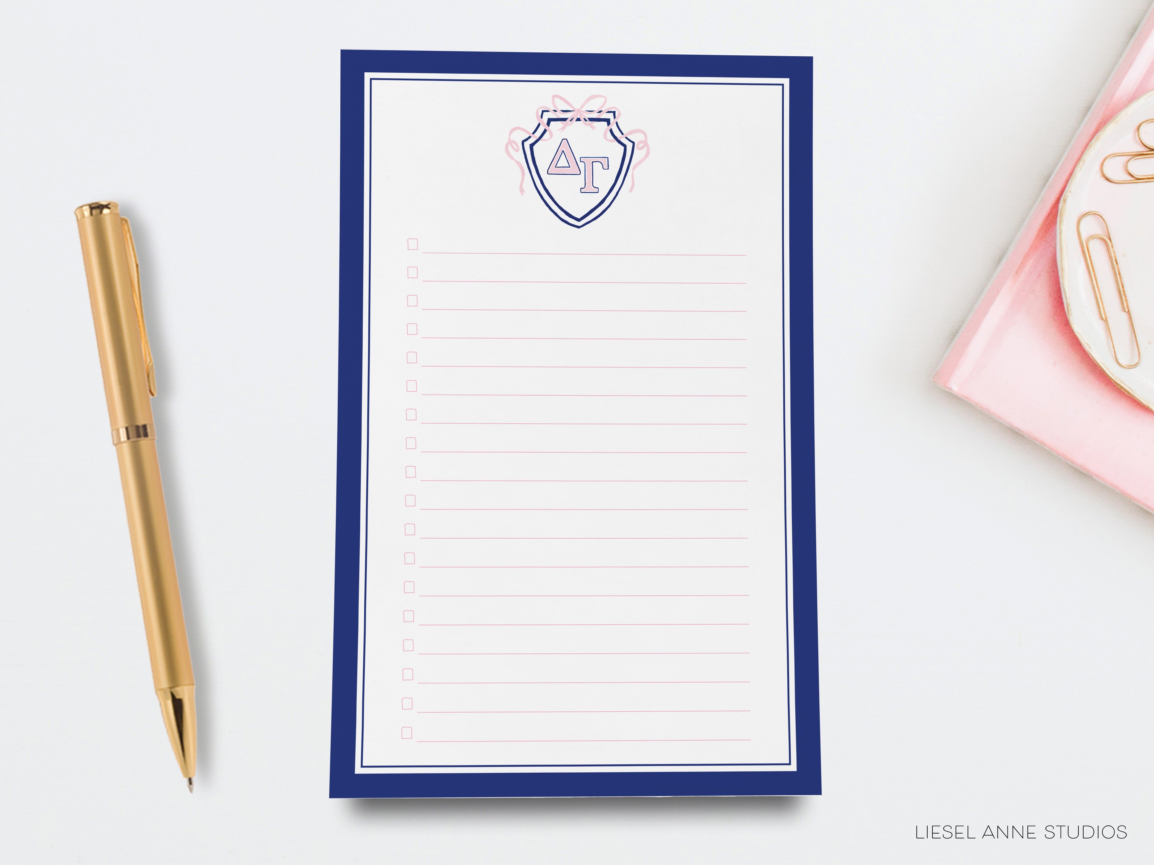 a notepad with a pen next to it on a desk