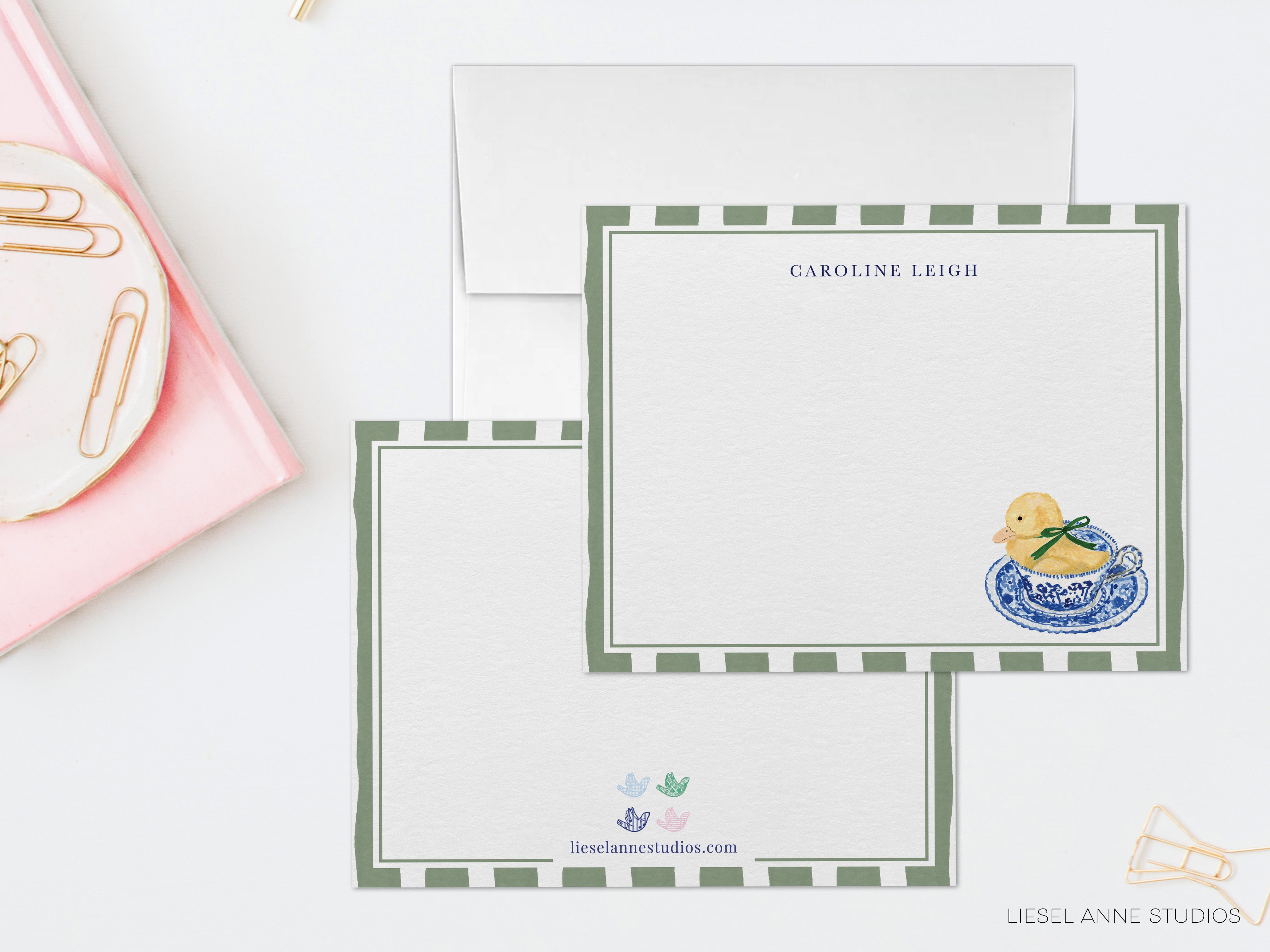 two blank greeting cards with a decorative border and a small illustration of a yellow duck on a blue and white plate.