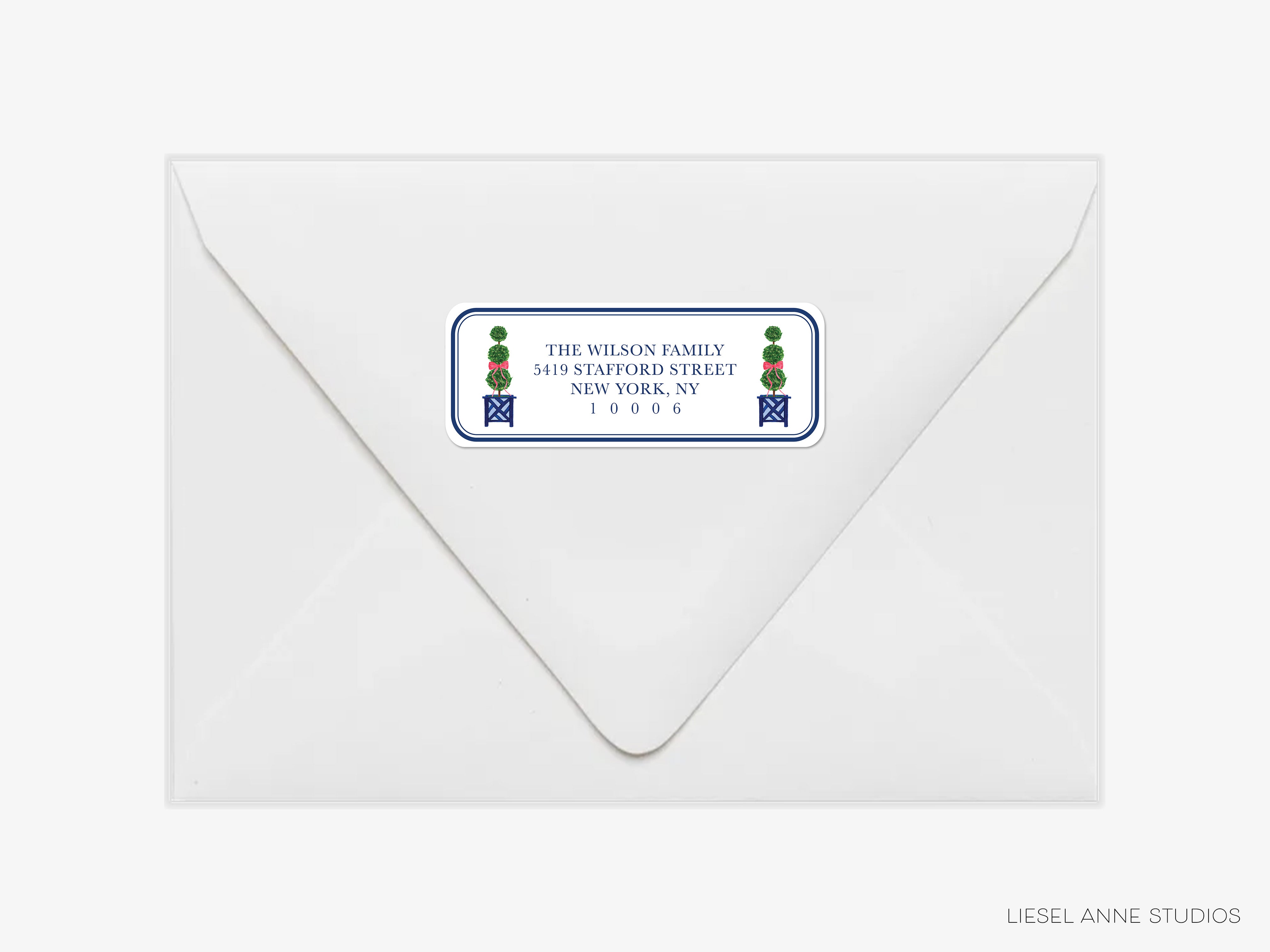 a white envelope with a blue and green label on it, which appears to be a postal address label.