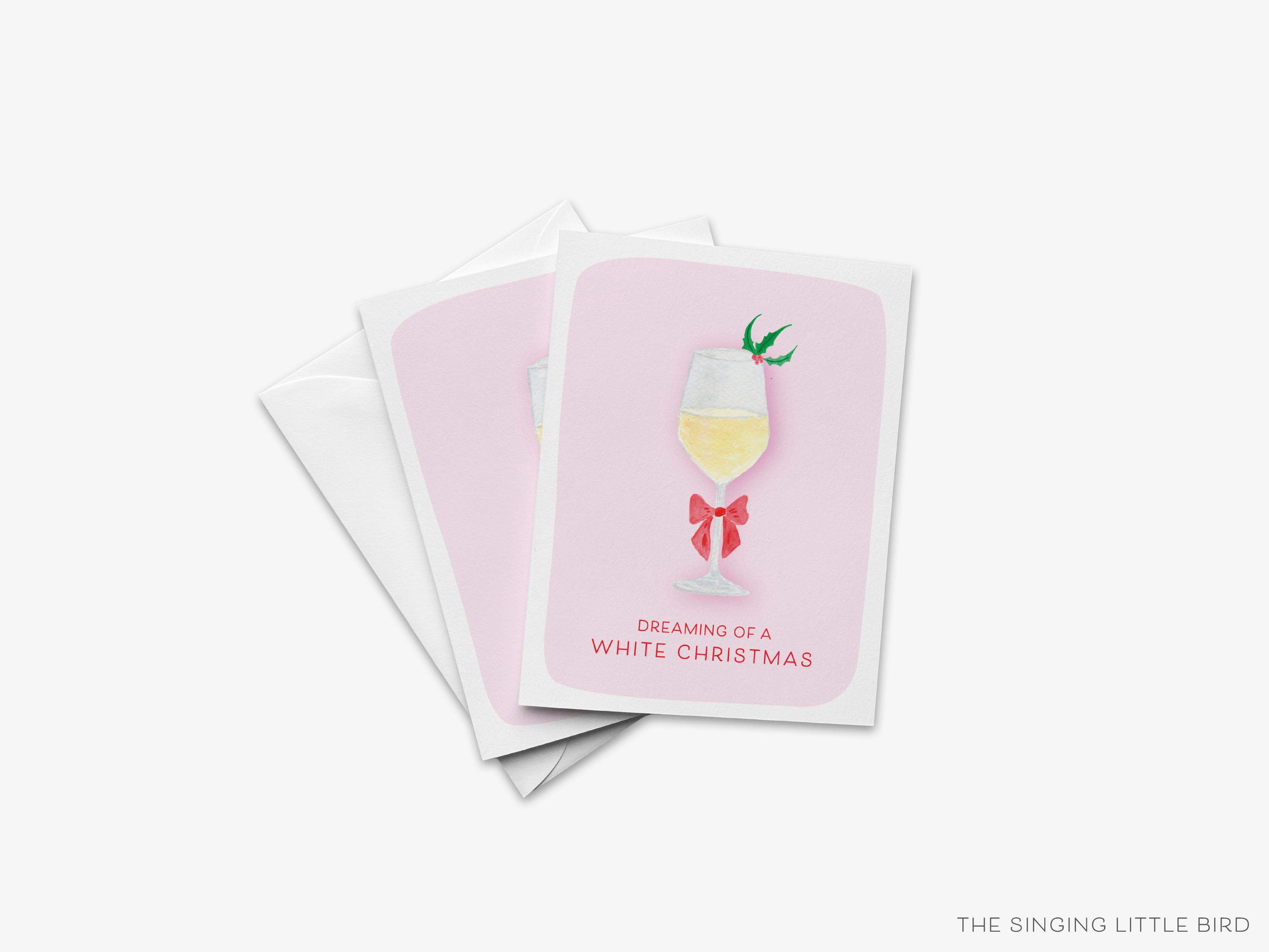 A set of three greeting cards with a pink background and a white wine glass illustration. The text on the cards reads "Dreaming of a WHITE CHRISTMAS".