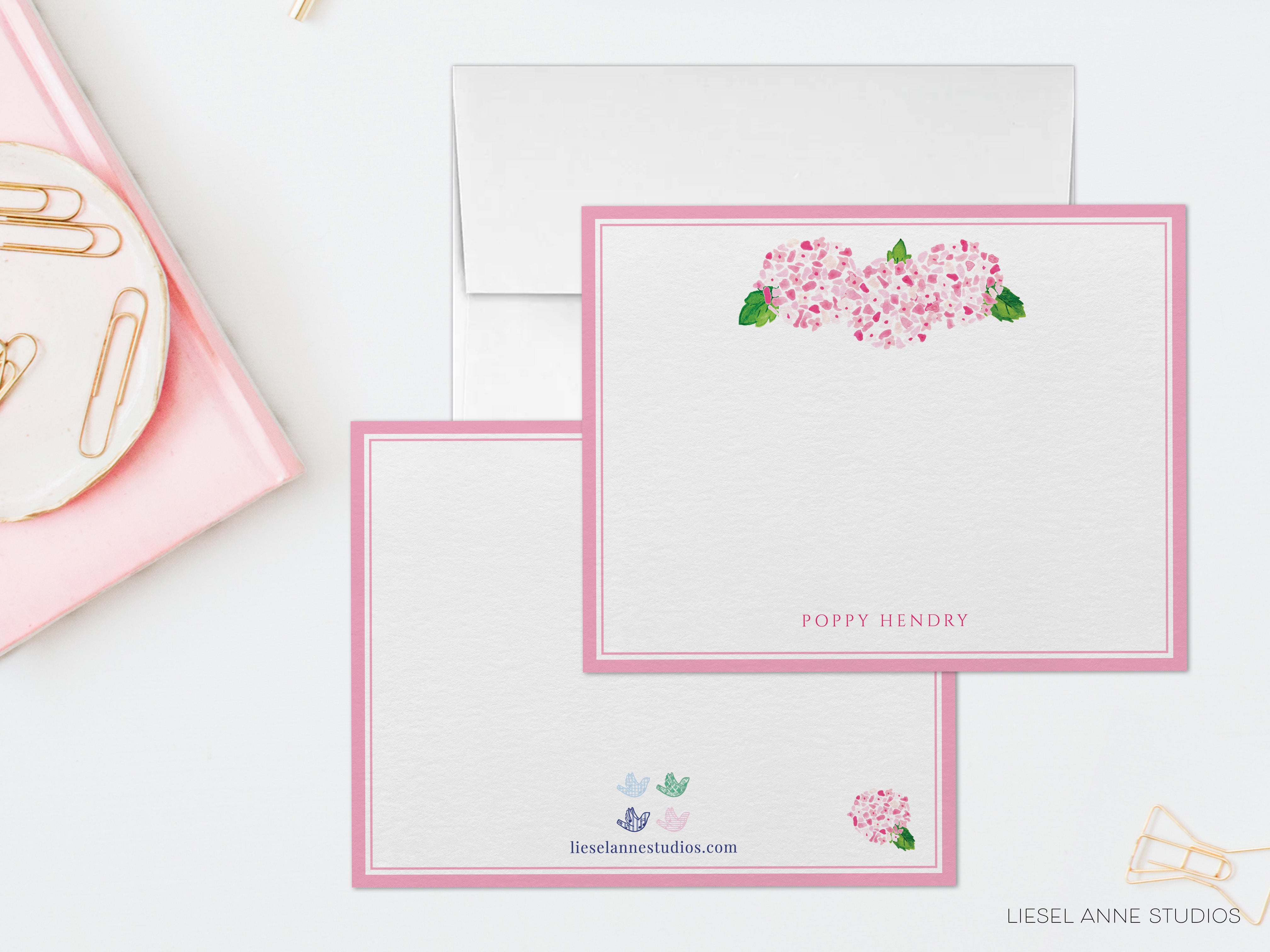 a pink and white stationery with pink flowers on it