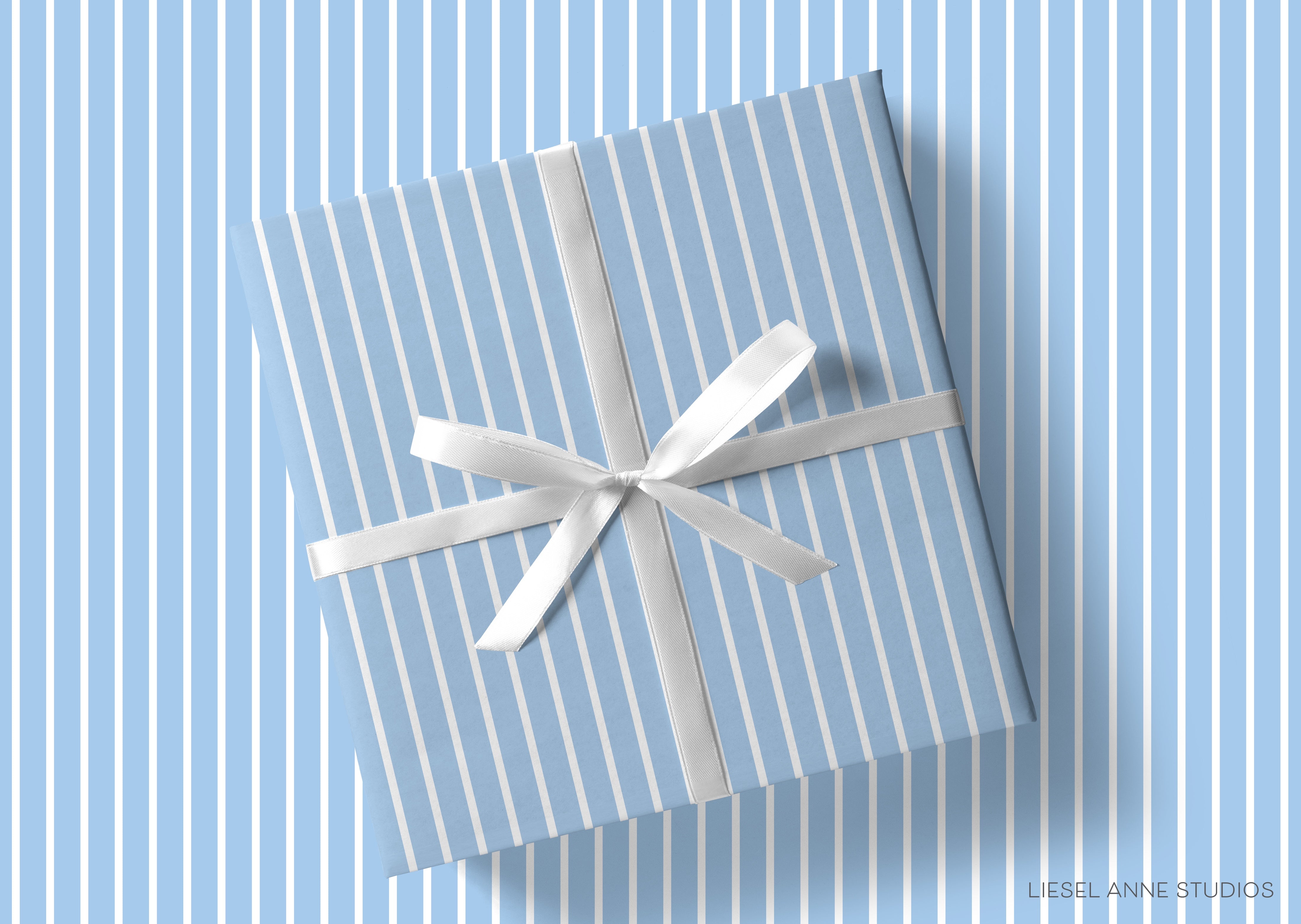 A gift box with a white ribbon tied around it, placed on a blue striped background.