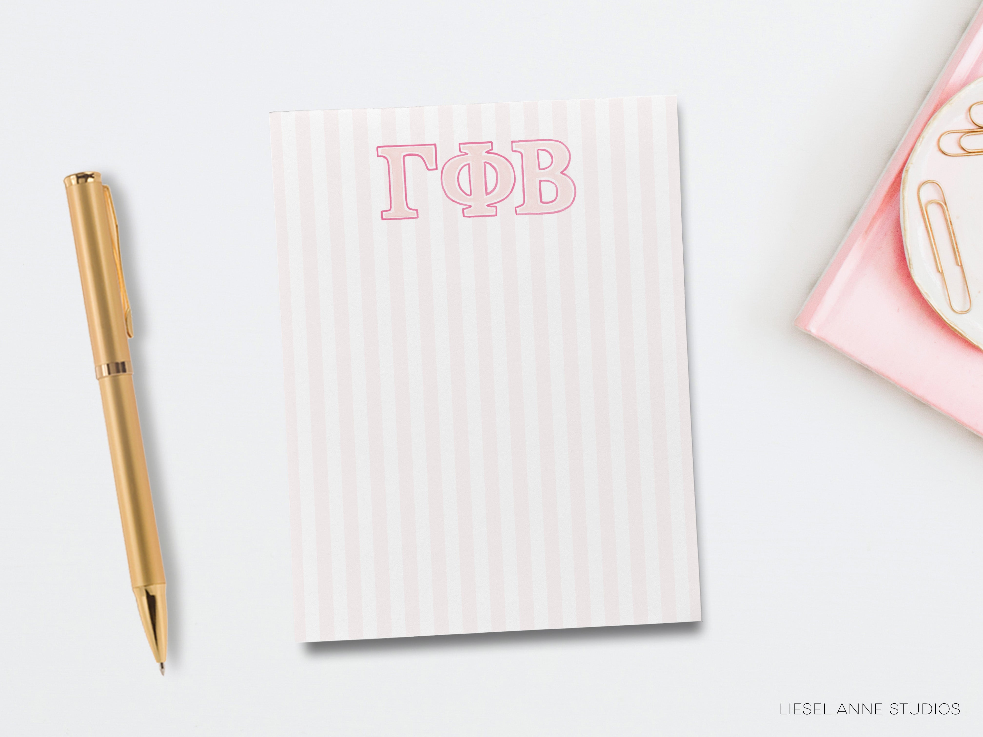 a notepad with the letter t o b on it next to a pen