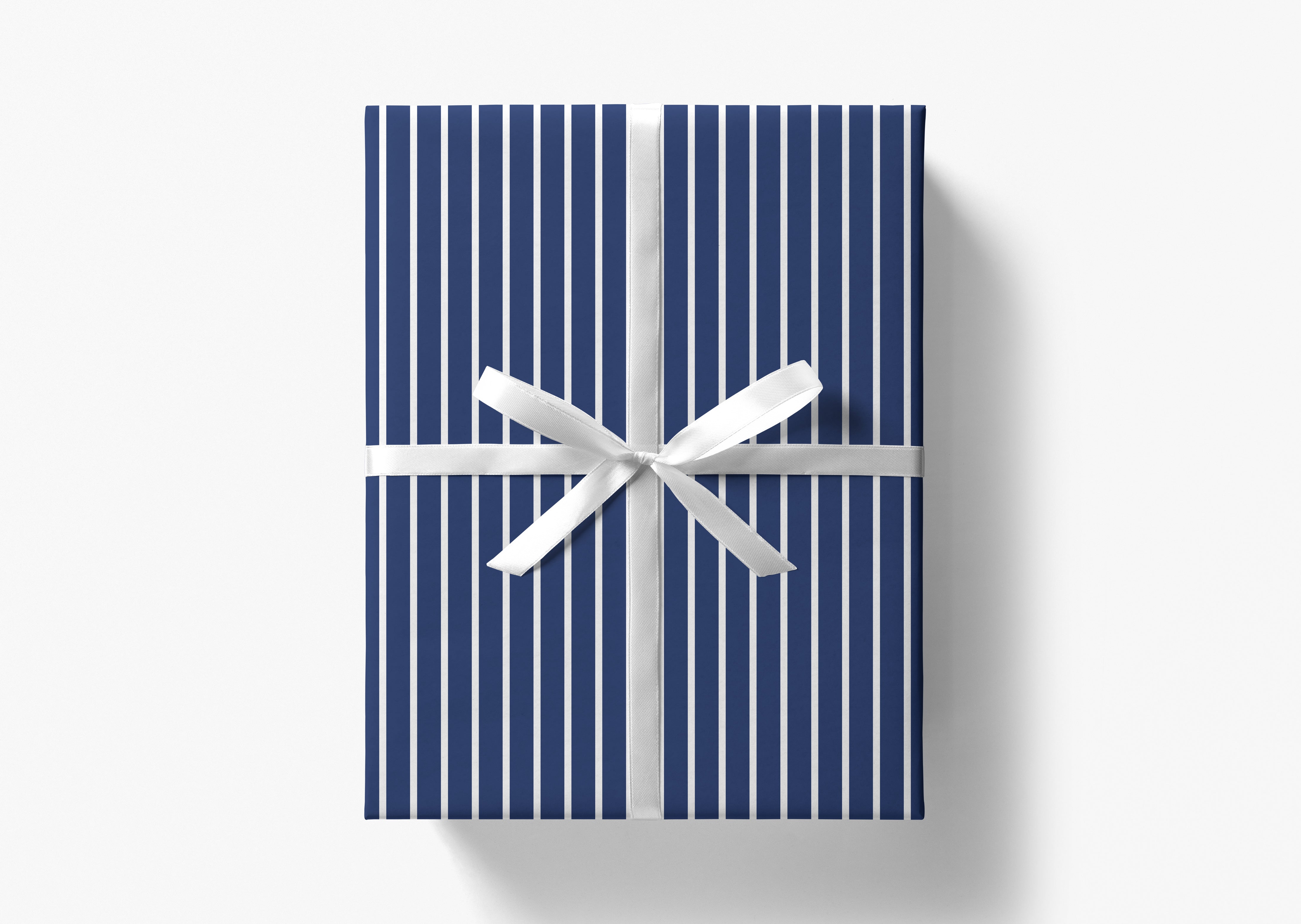 A blue gift box with a white ribbon tied around it, set against a white background.