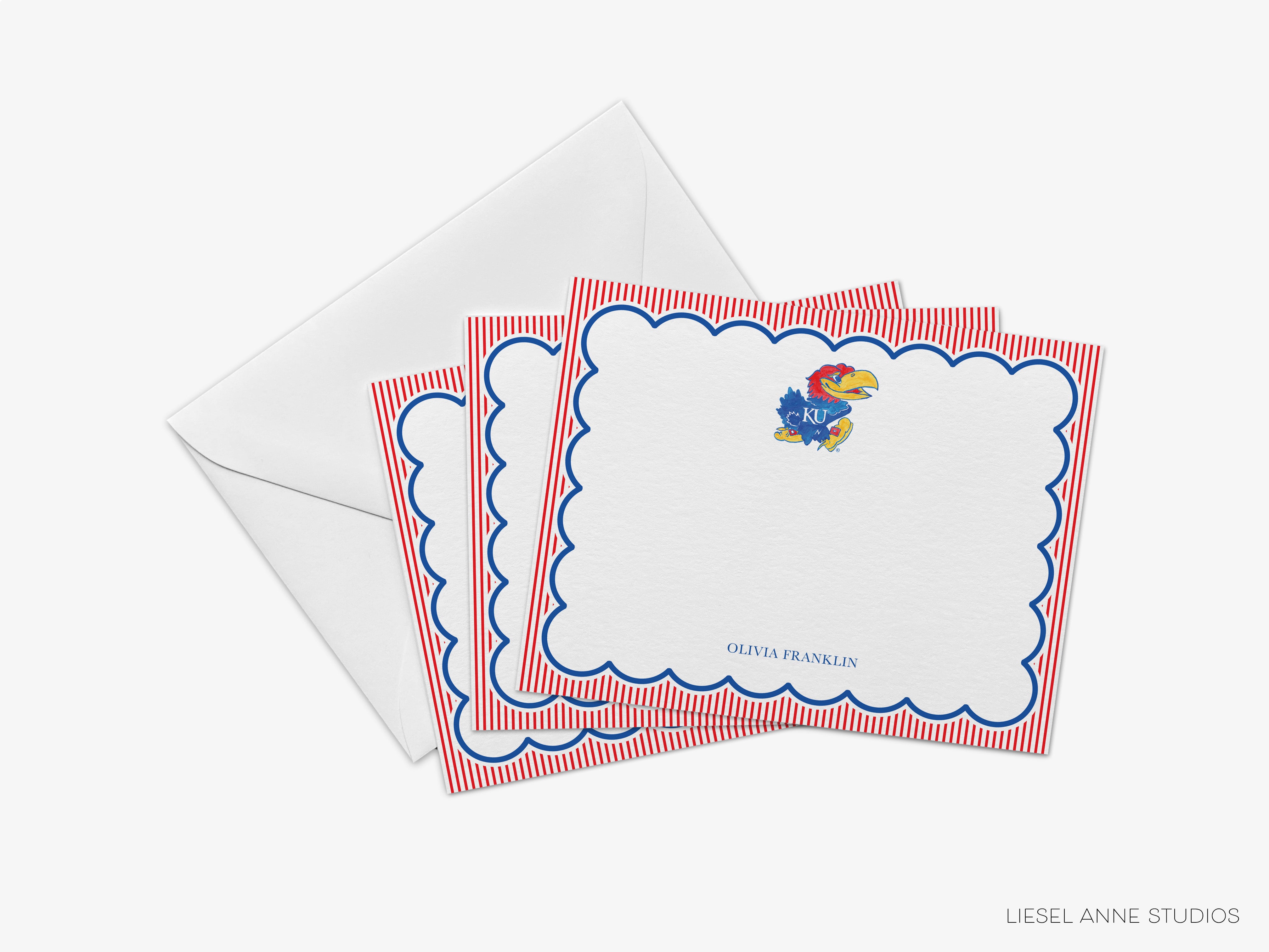 A set of personalized stationery cards with a Kansas City University (KCU) logo and a scalloped edge, along with an envelope.