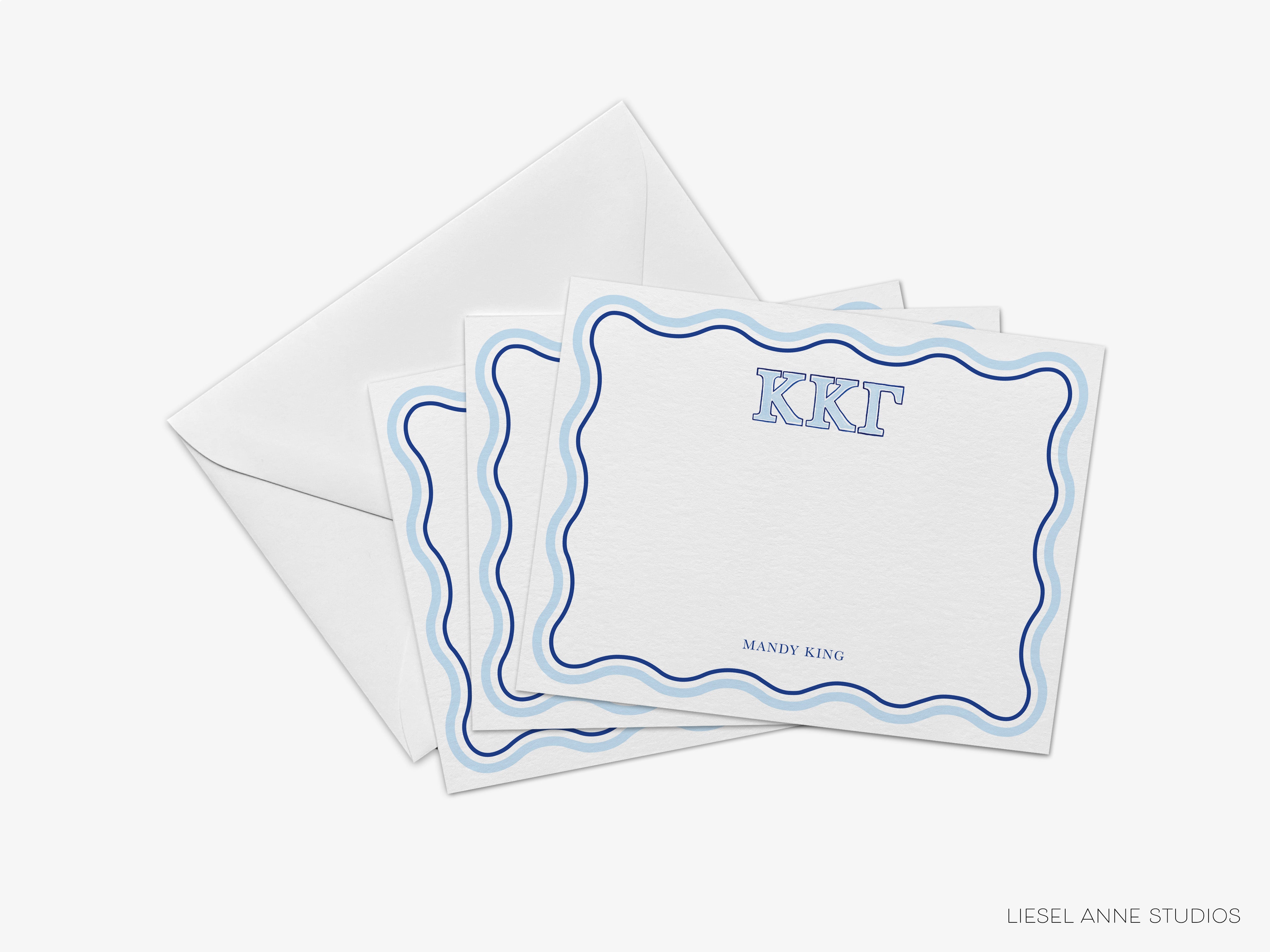a set of three envelopes with a monogrammed design