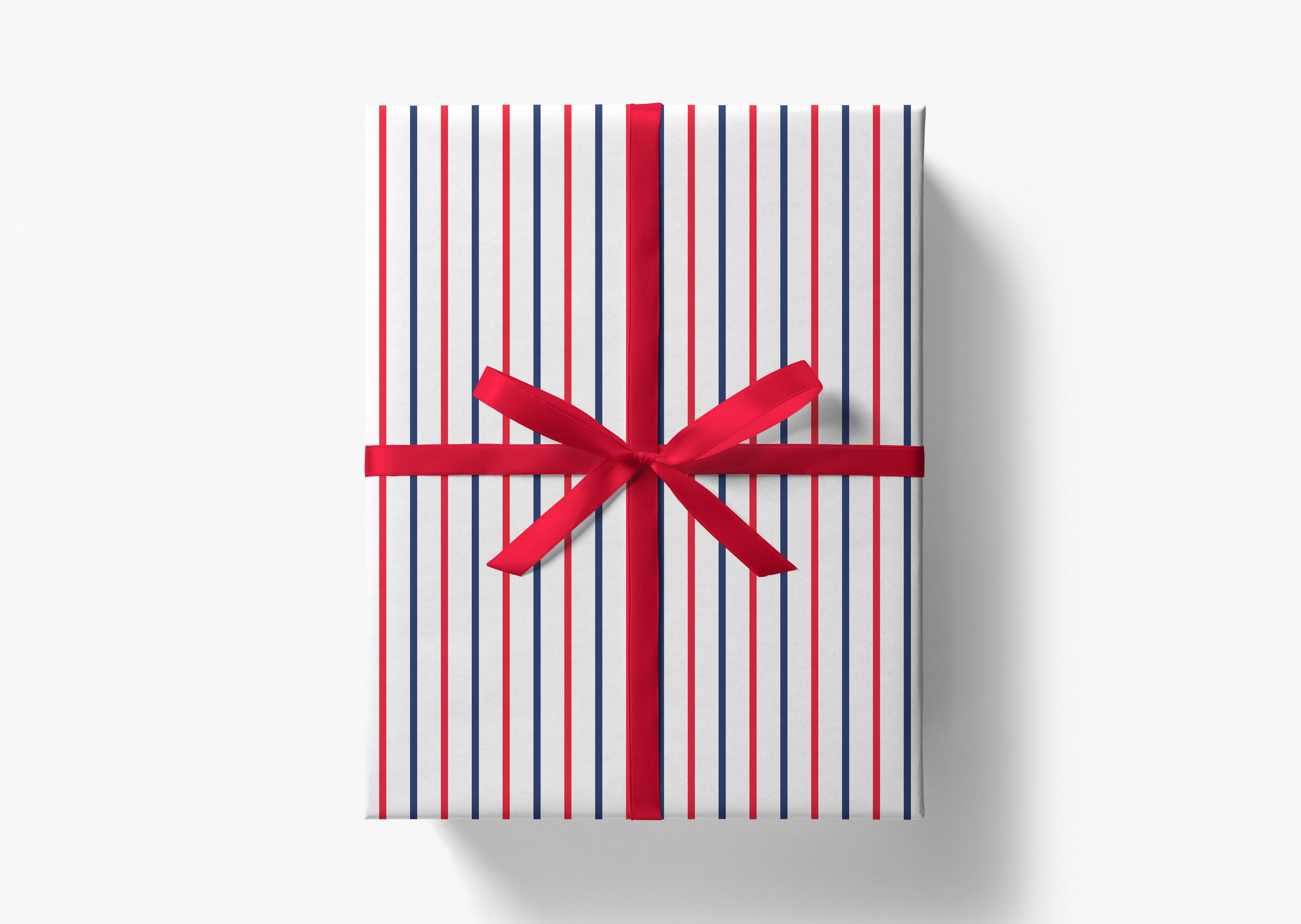 A gift box wrapped in a striped paper with a red ribbon tied in a bow.