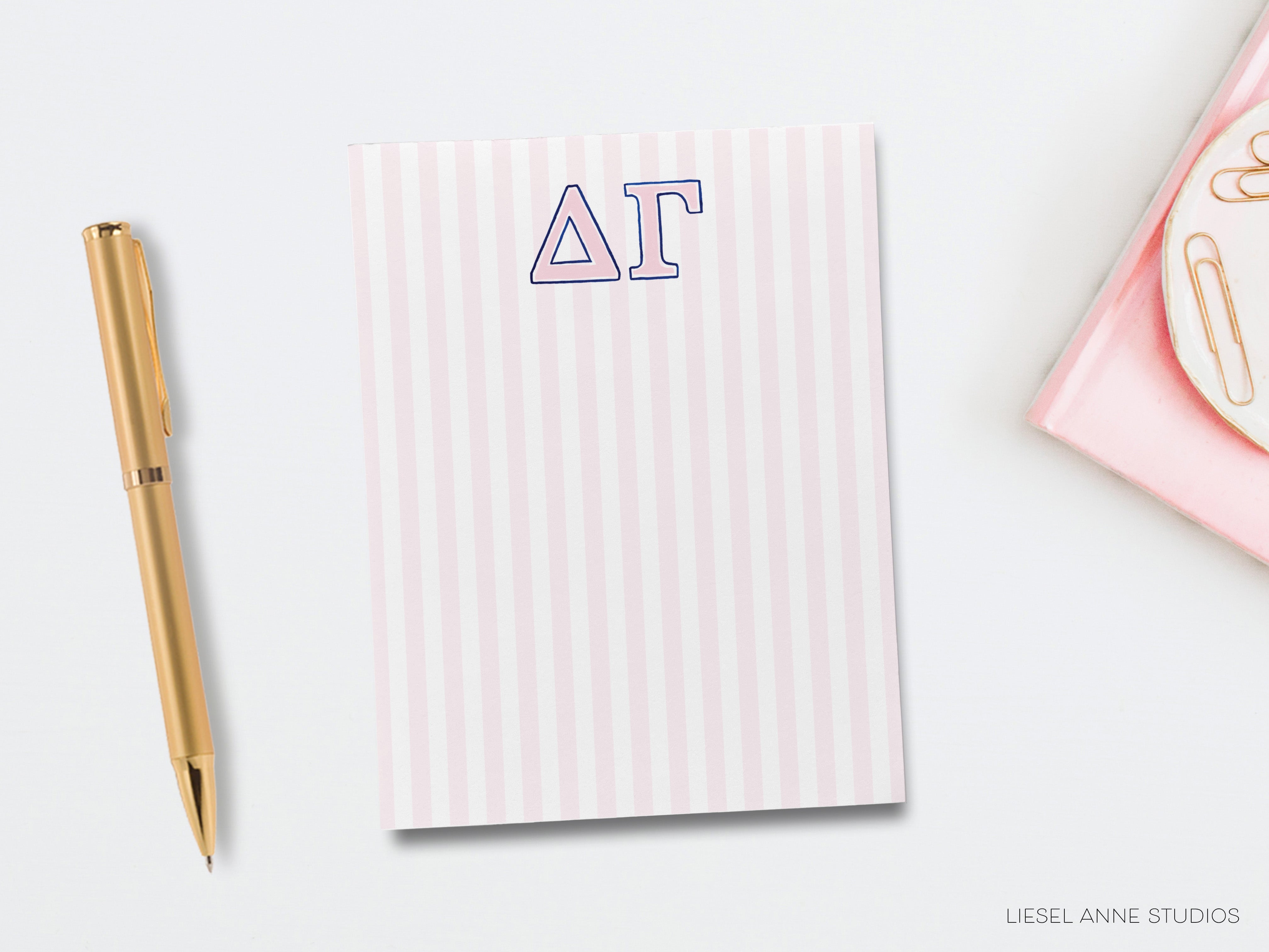 a notepad with the word at on it next to a pen