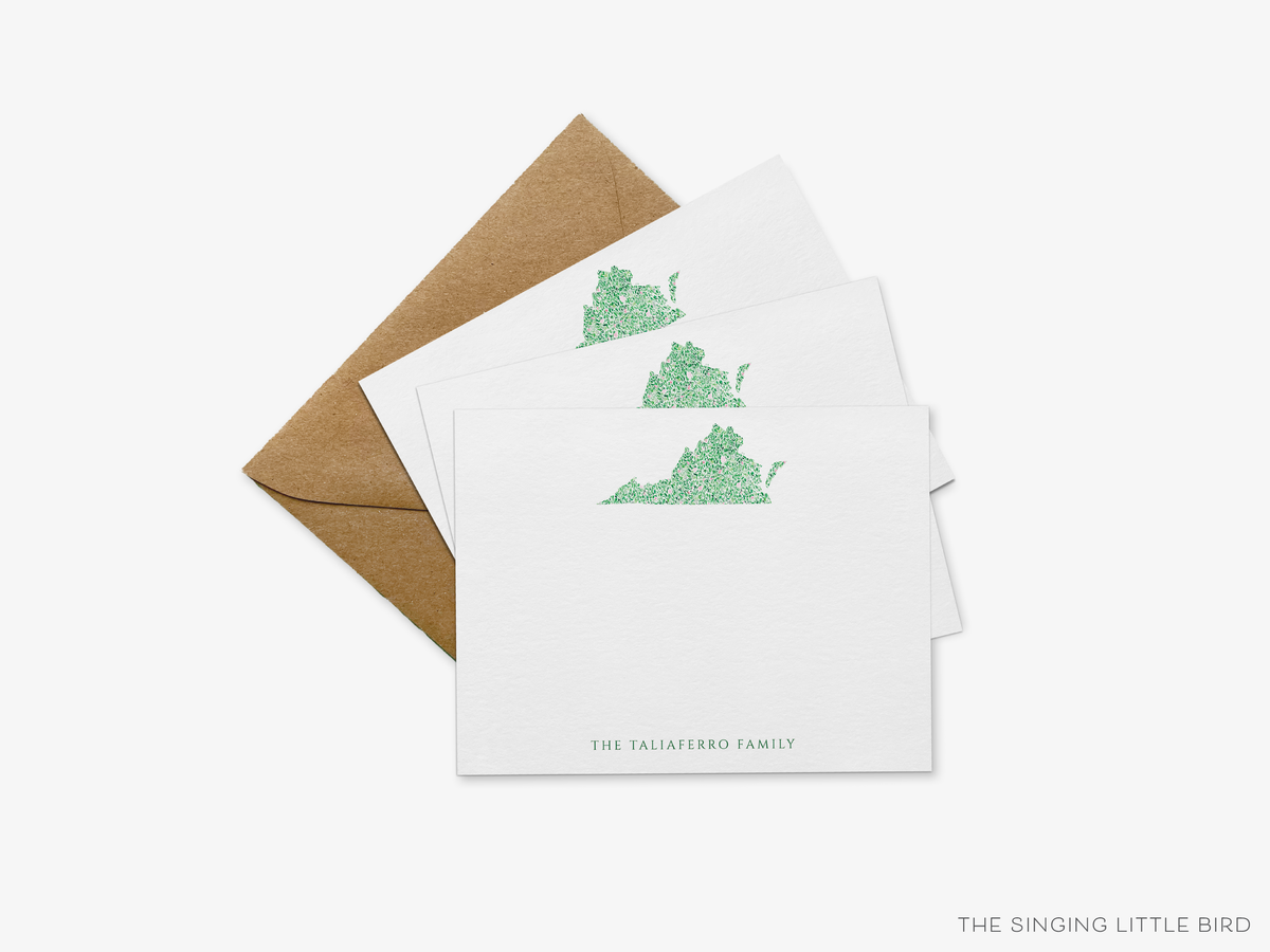 a set of three white cards with a green graphic of a state, and a brown envelope.