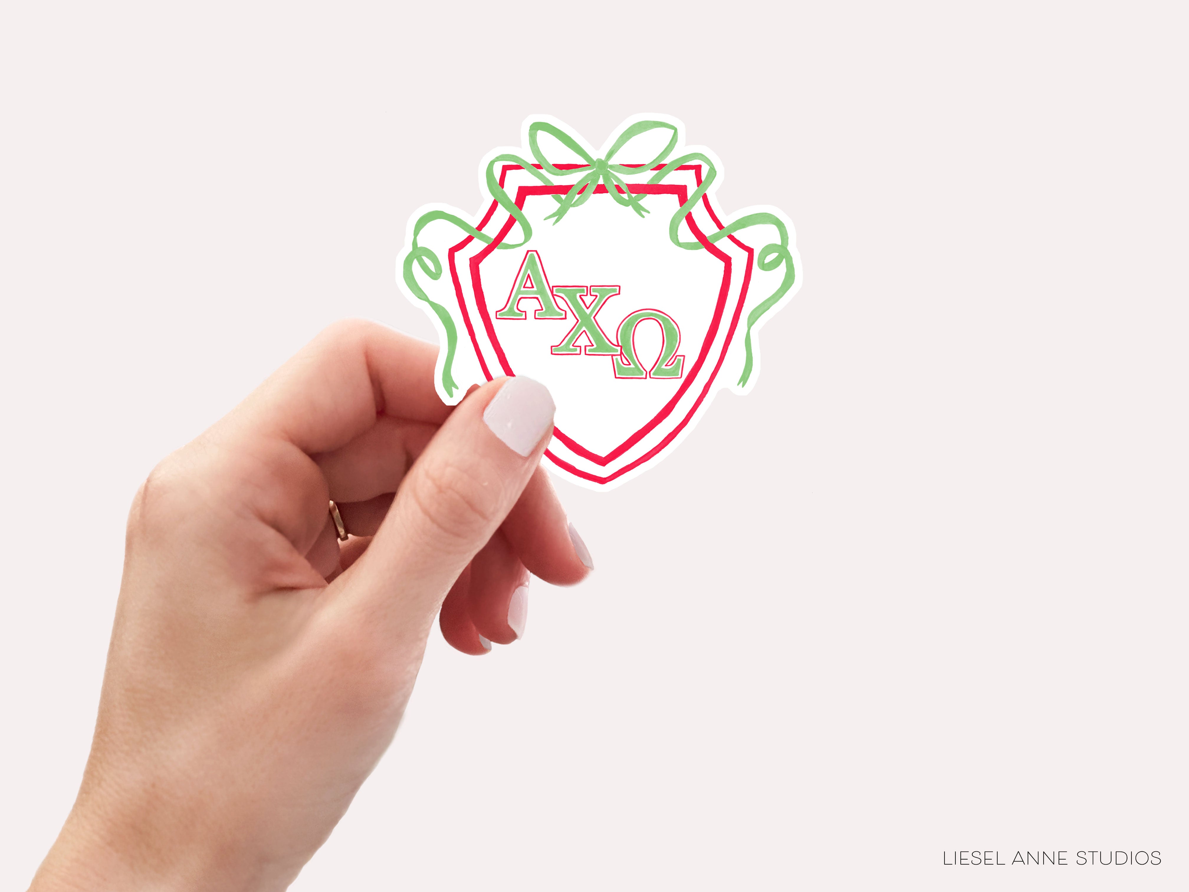 a hand holding a sticker with the word ao on it