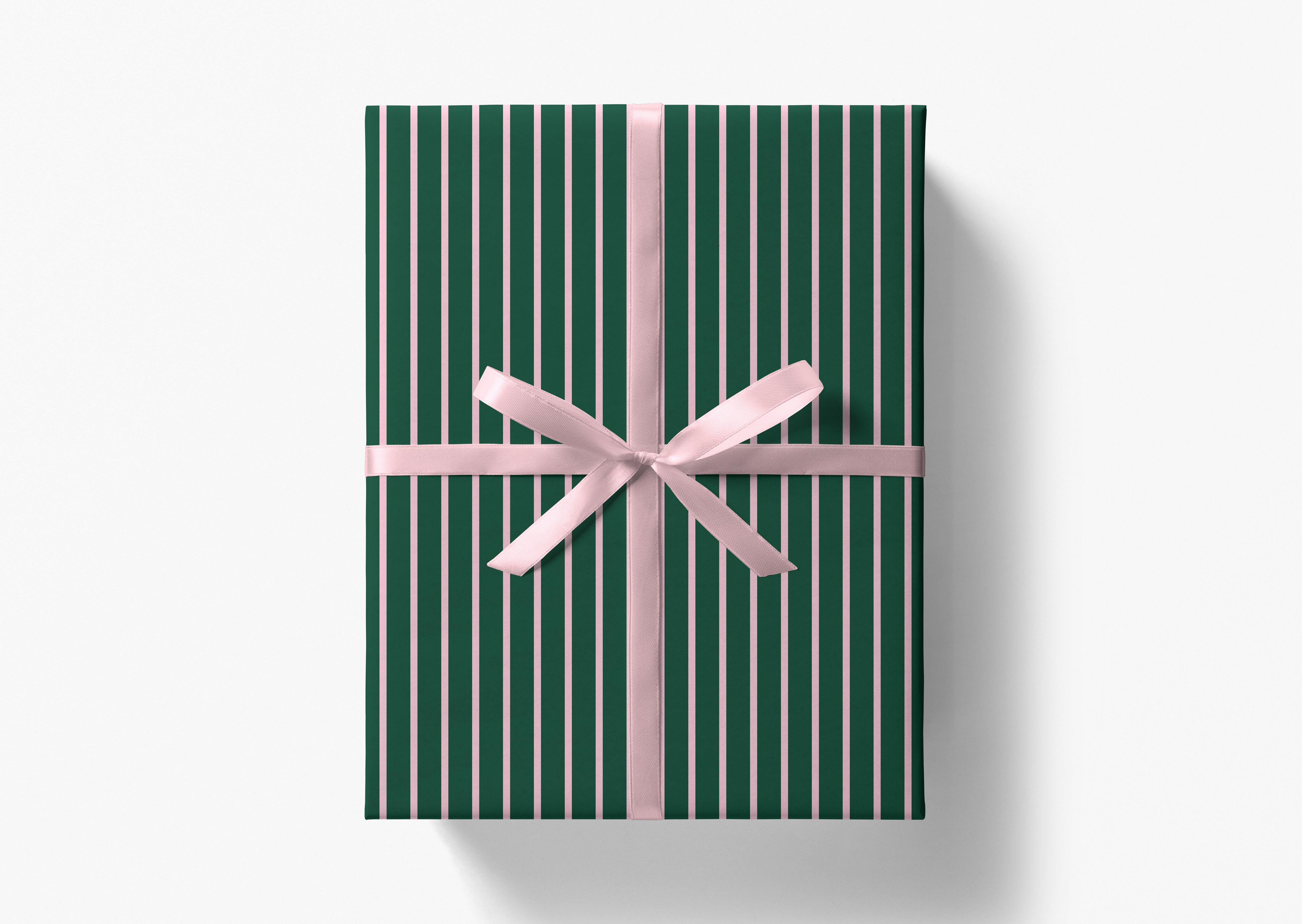 A green gift box with a pink ribbon bow tied around it.