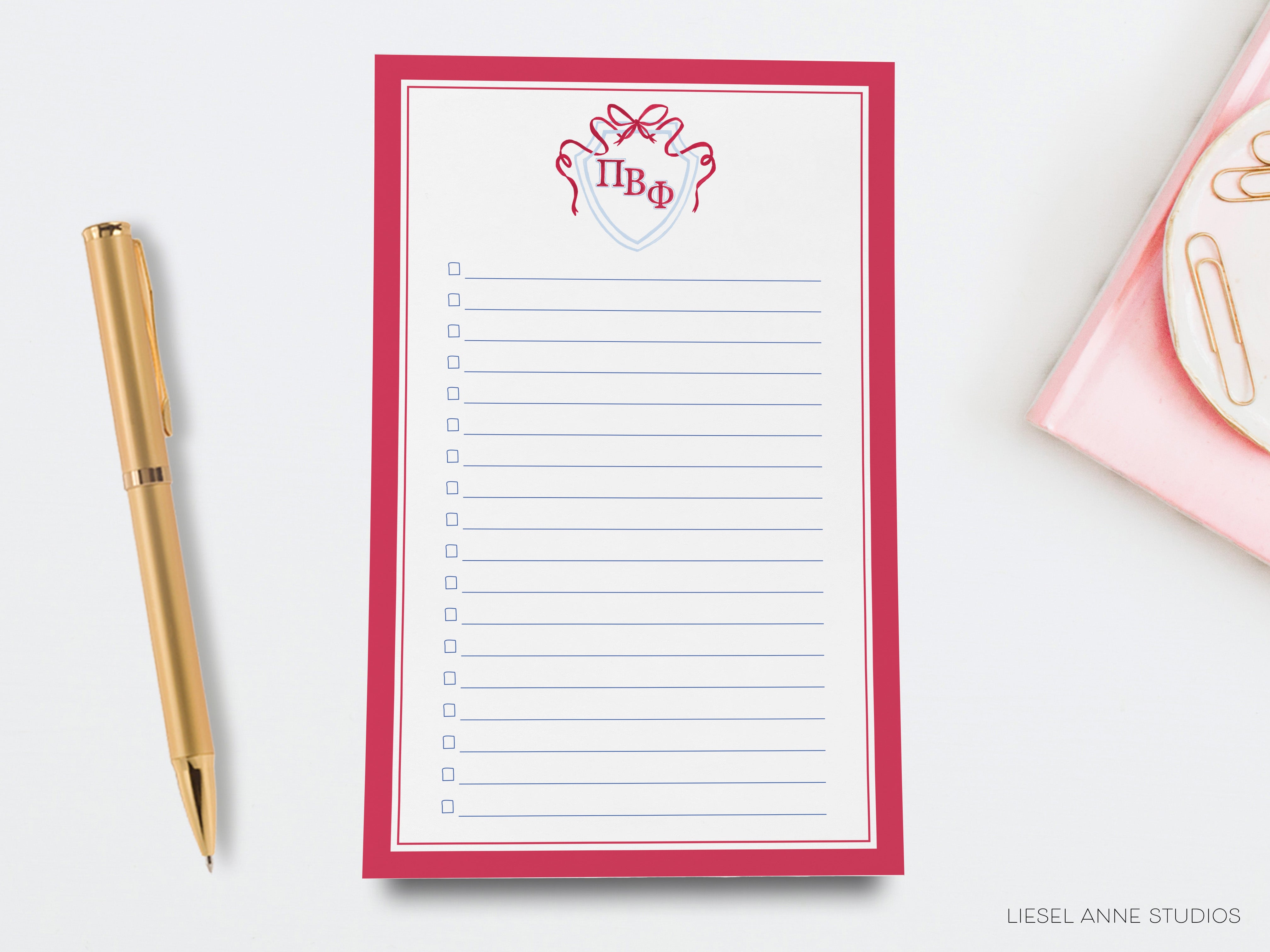 a notepad with a hand drawn crown on it next to a pen