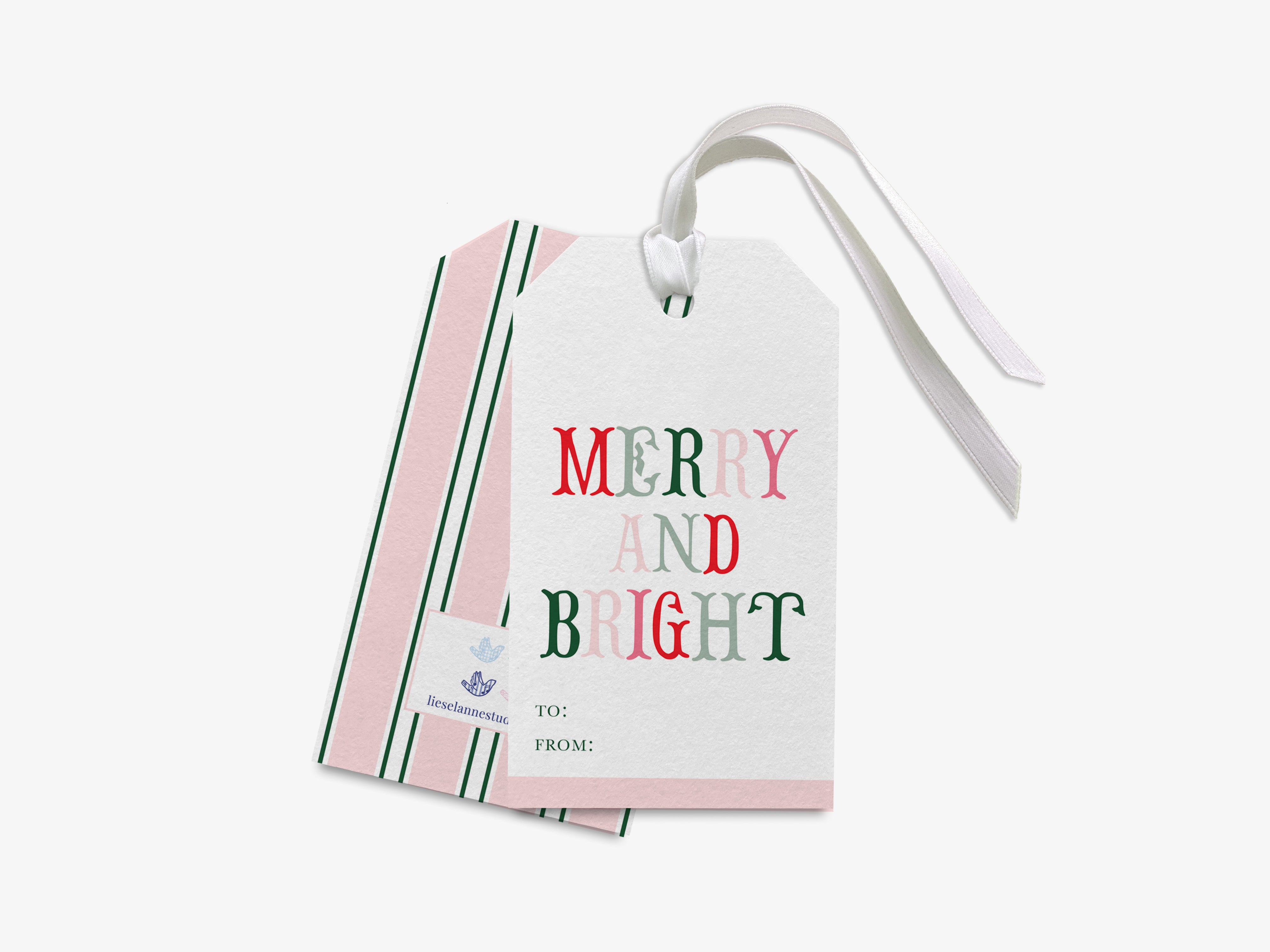 a pair of white gift tags with a festive message, "MERRY AND BRIGHT", printed on them.