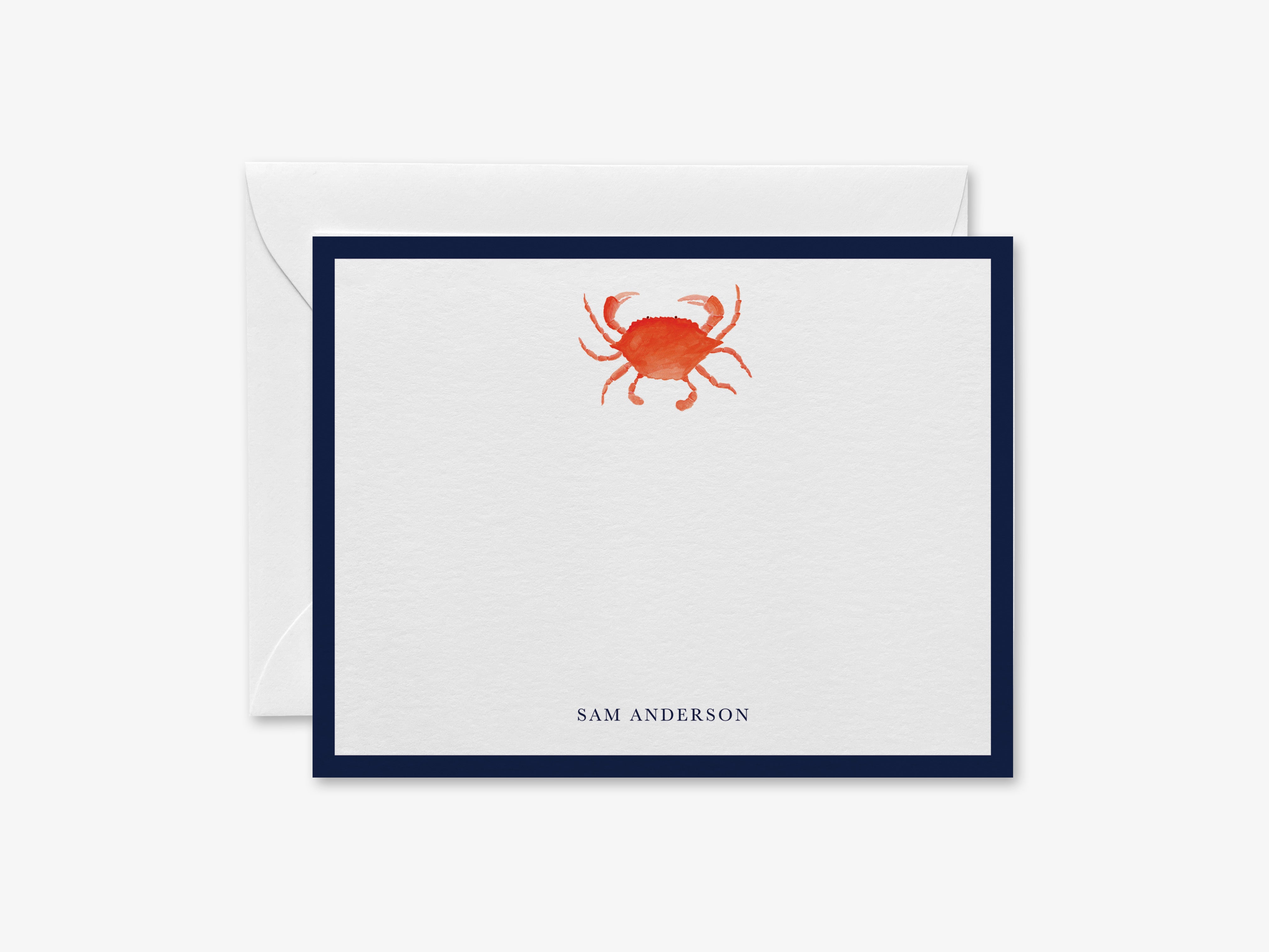 A white card with a blue border, featuring an illustration of a red crab on the front.