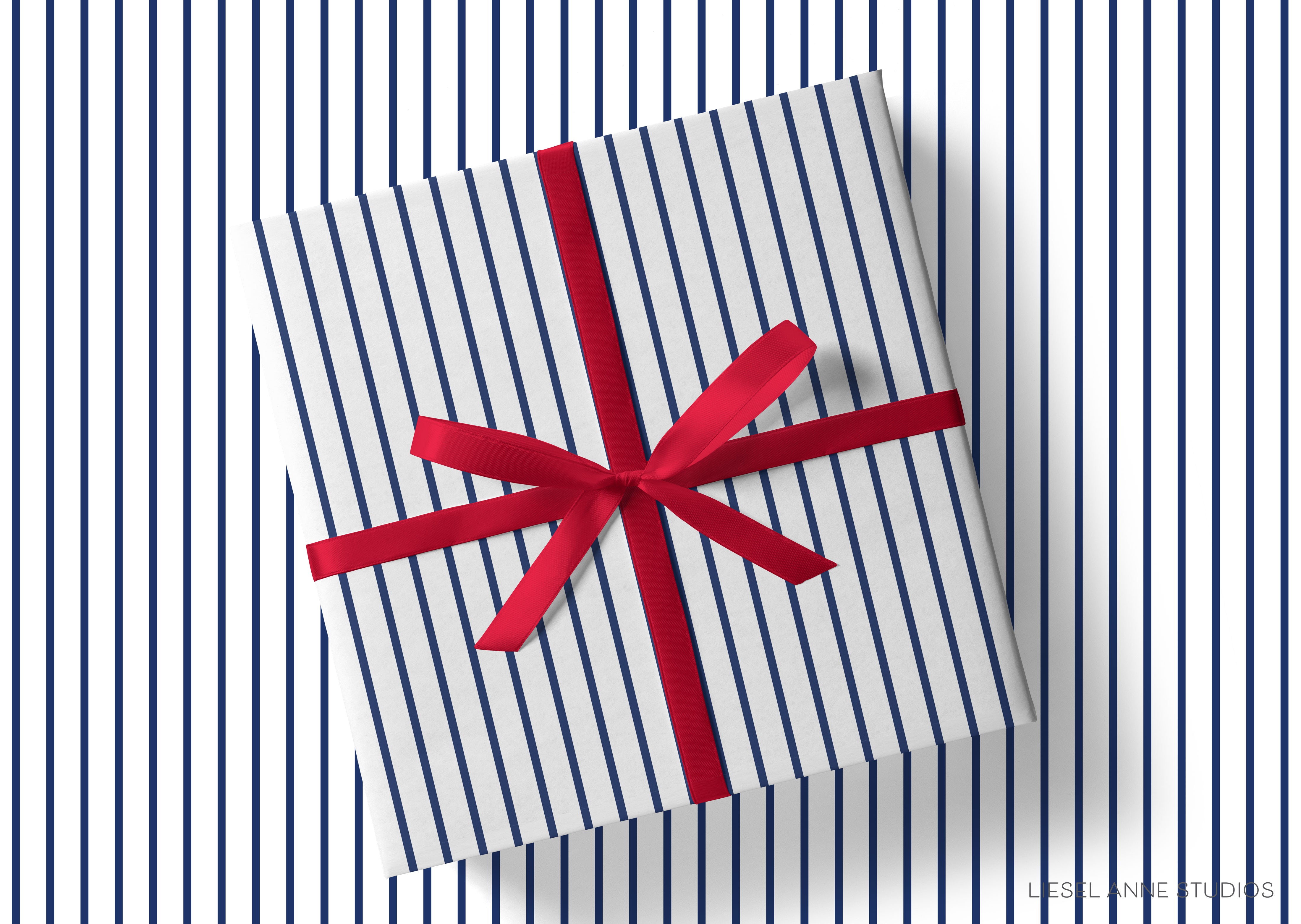 A gift box with a red ribbon tied around it, placed on a background of blue and white striped vertical lines.