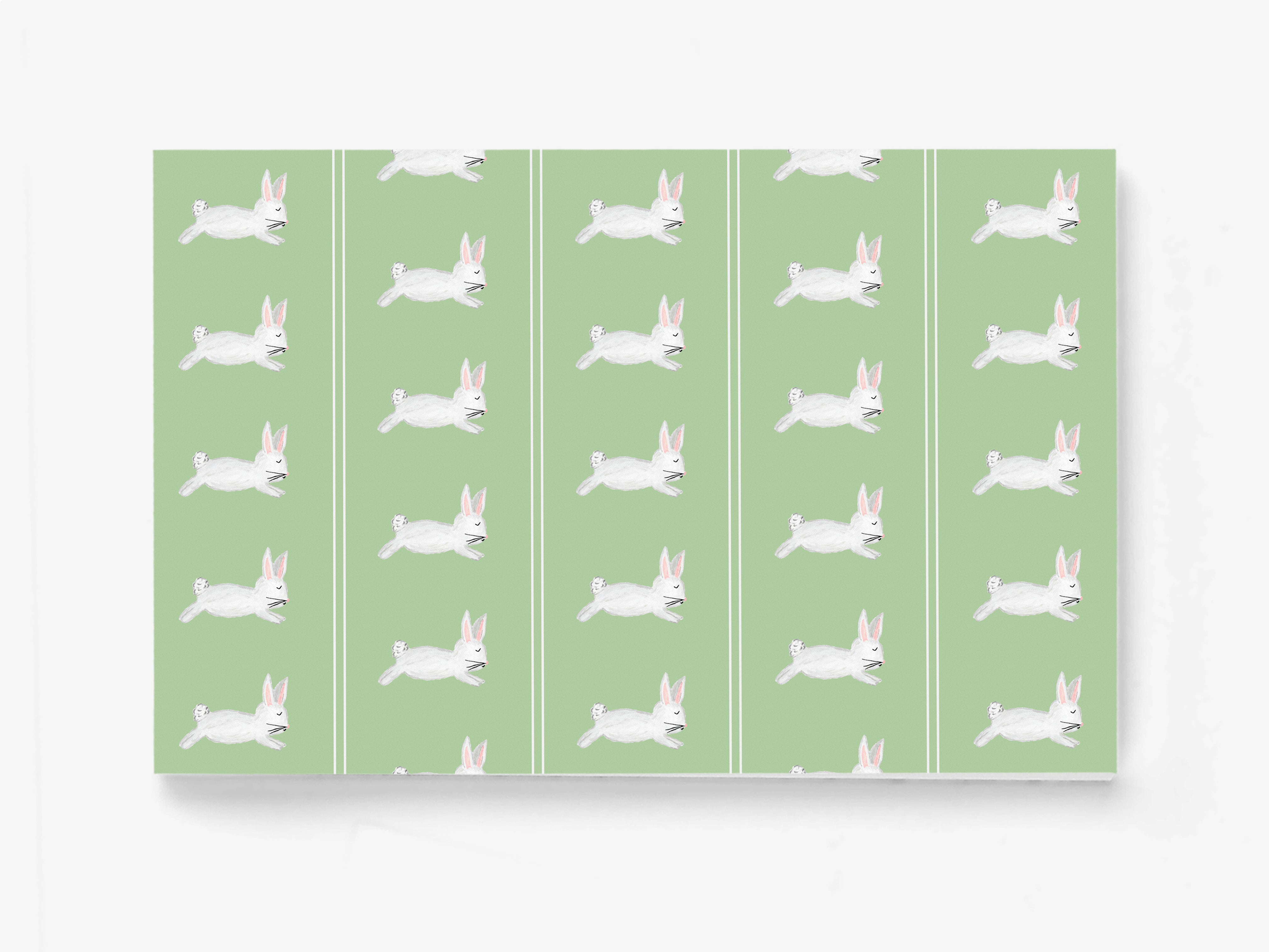 a repeating pattern of white rabbits against a green background.