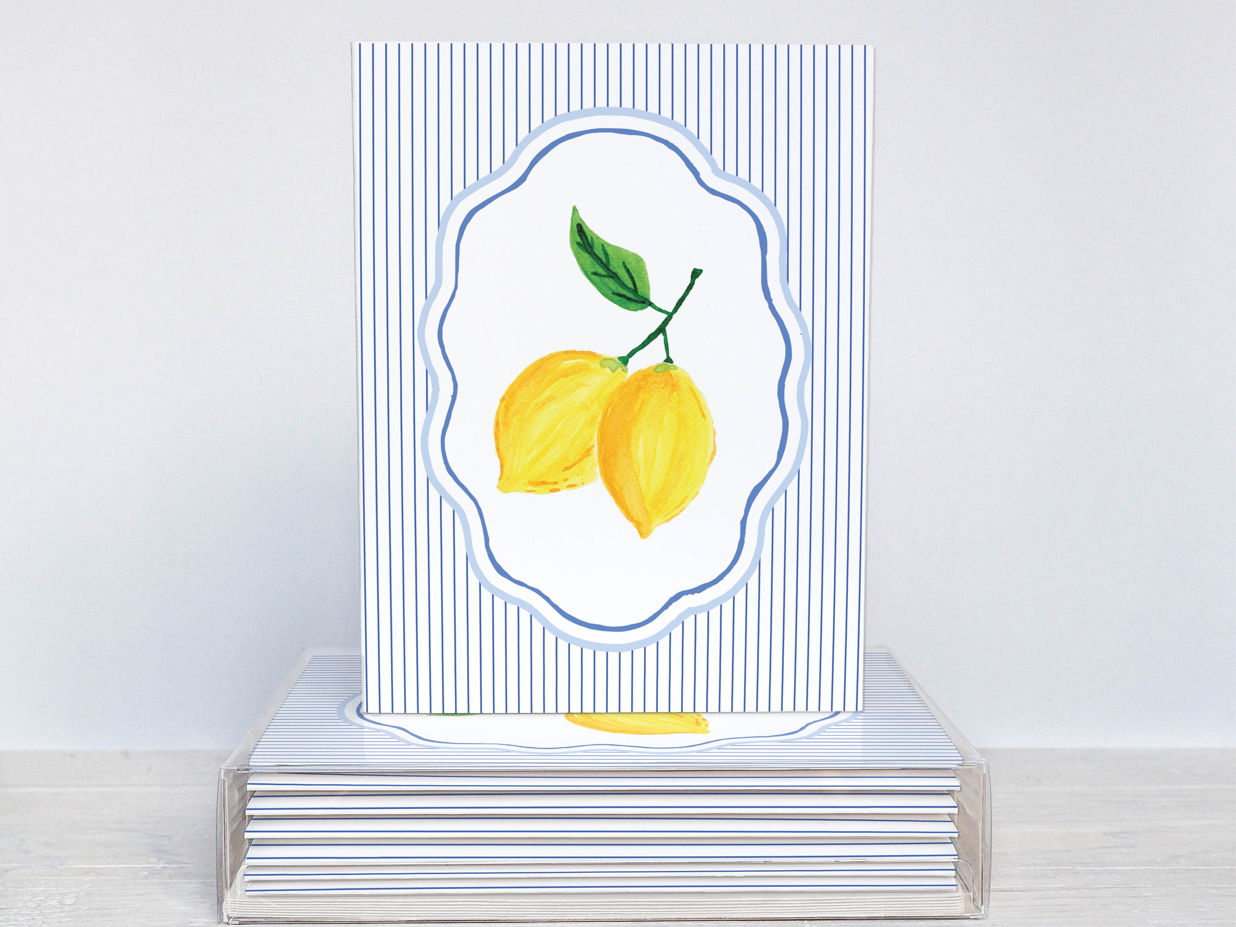 A white card with blue stripes and a picture of two lemons on it.