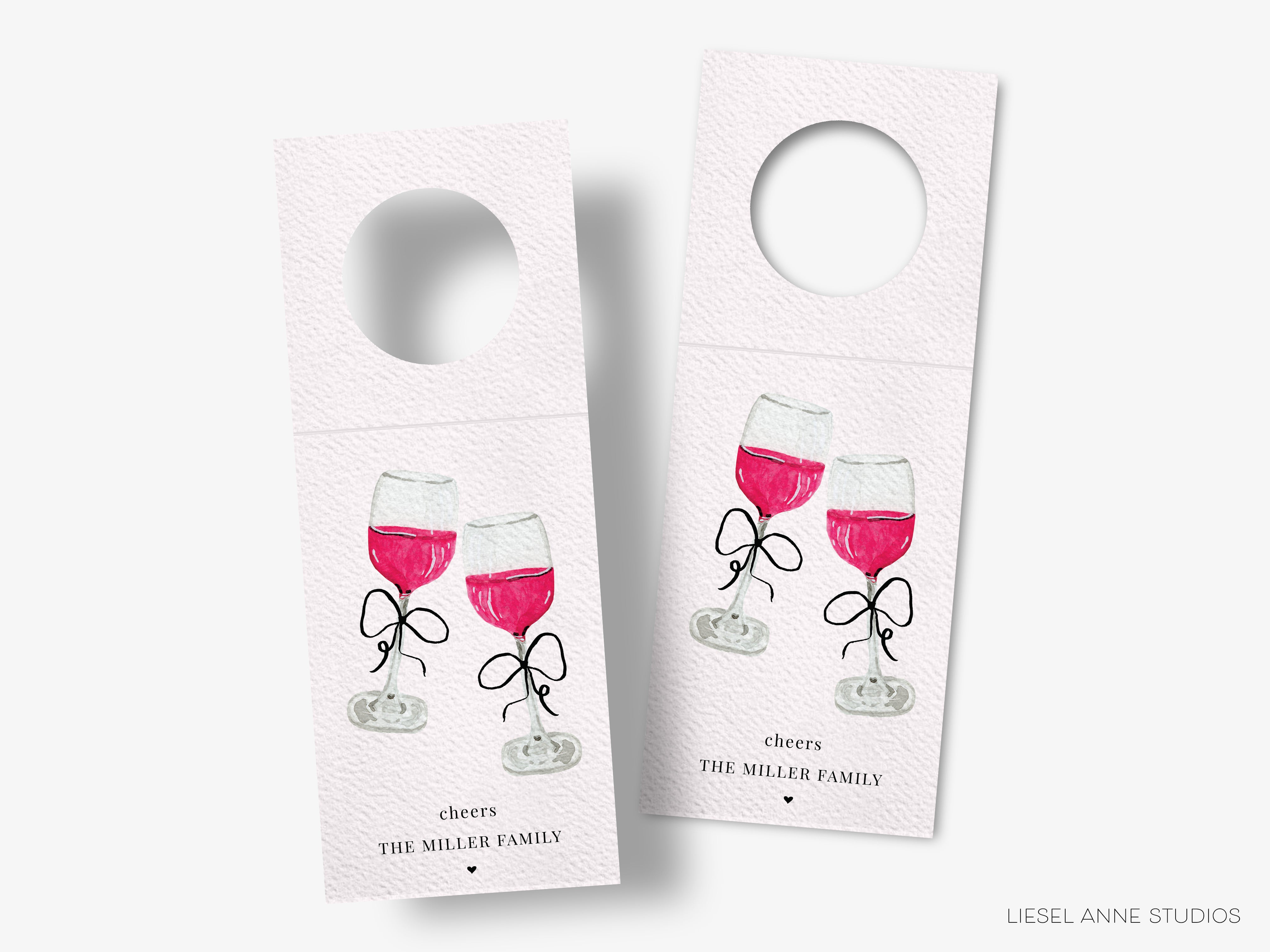two wine glass door tags with illustrations of wine glasses and text that reads "cheers THE MILLER FAMILY".