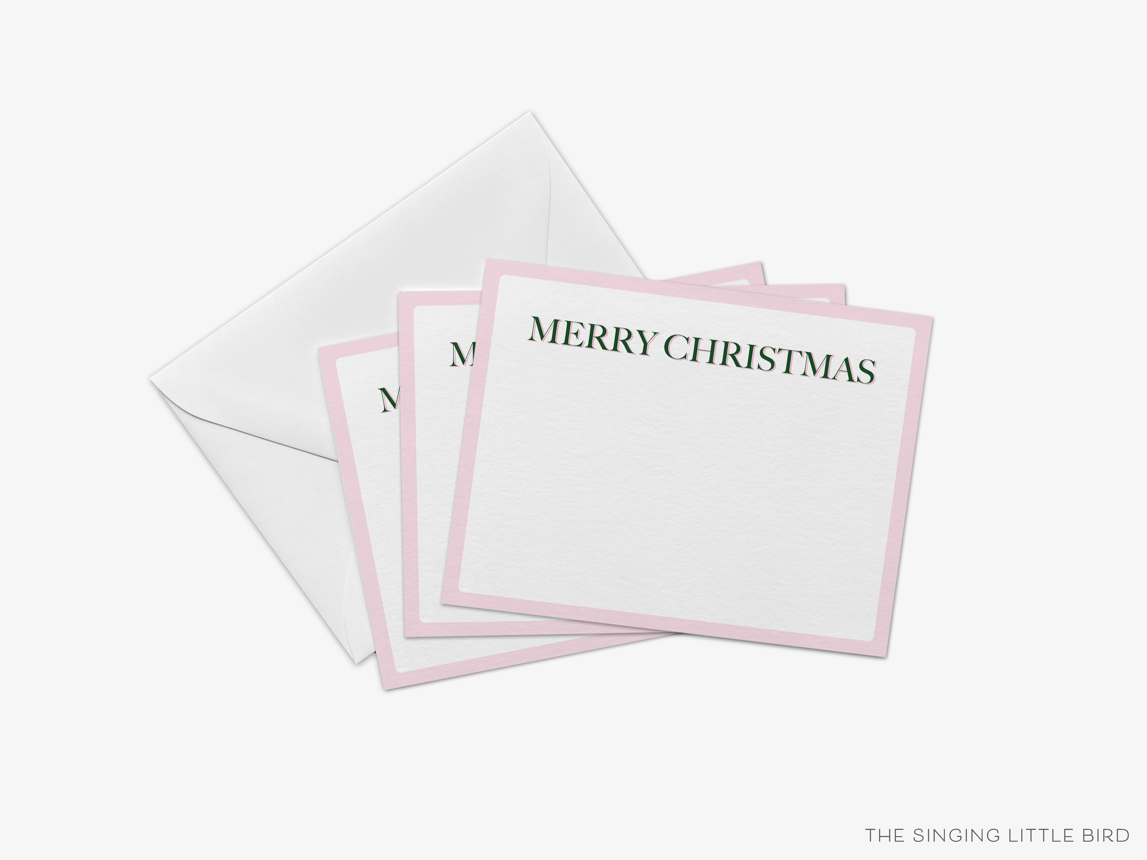 a set of pink and white greeting cards with the text "MERRY CHRISTMAS" printed on them, placed inside an envelope.