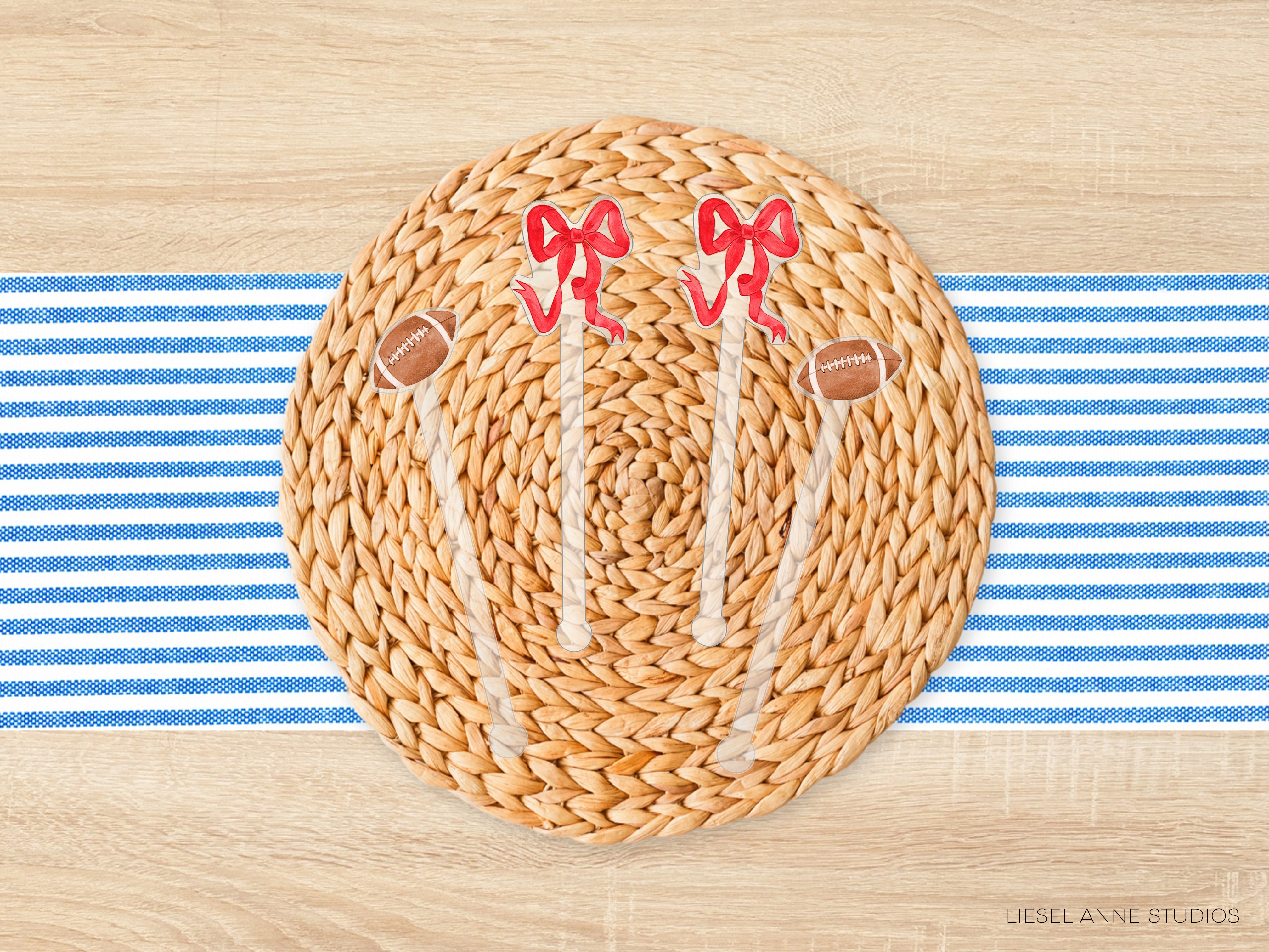 a woven placemat with a football motif, including two red bows and two brown footballs, placed on a blue and white striped tablecloth.