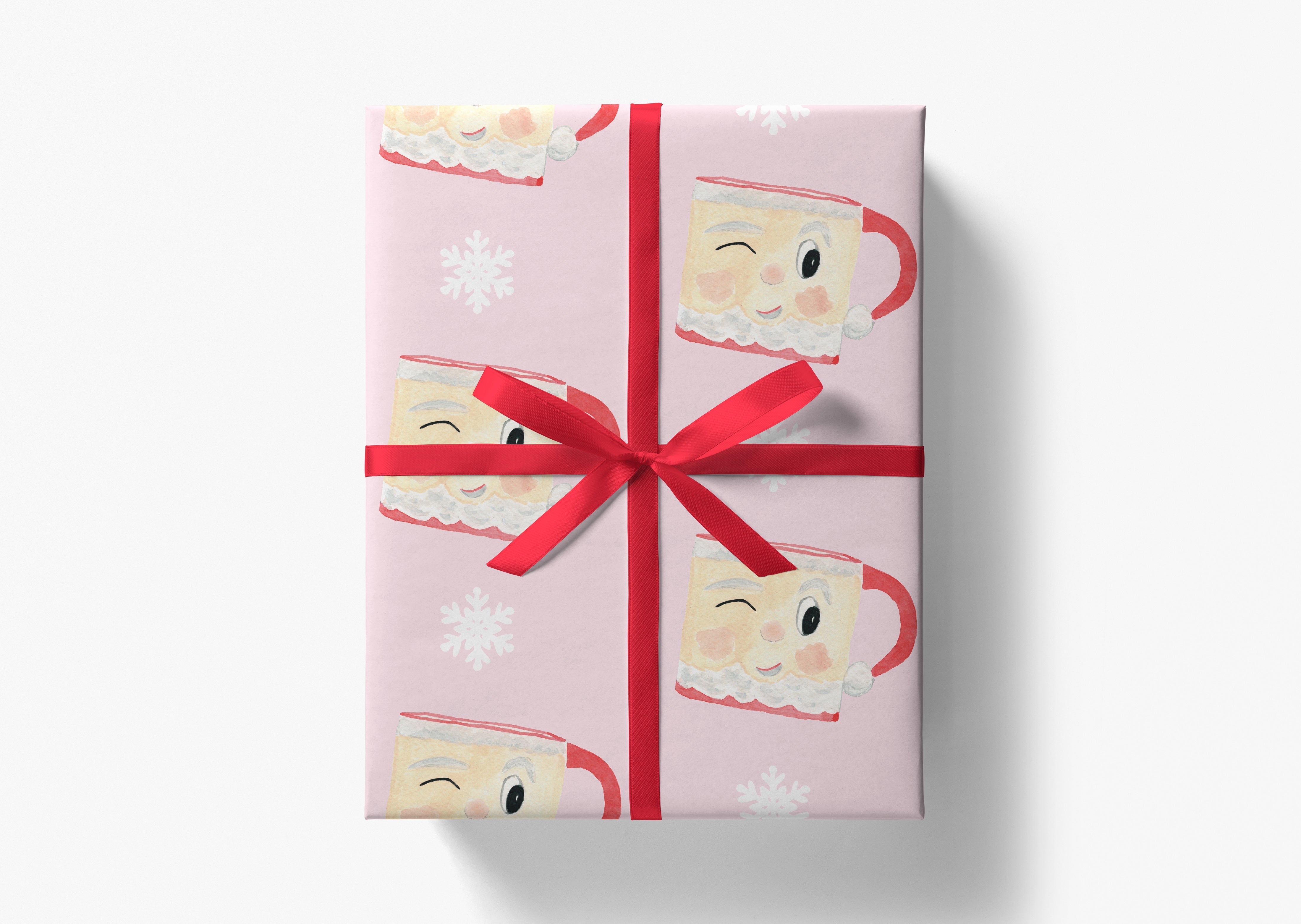A pink gift box with a red ribbon and a repeating pattern of smiling coffee mugs with snowflakes on a white background.