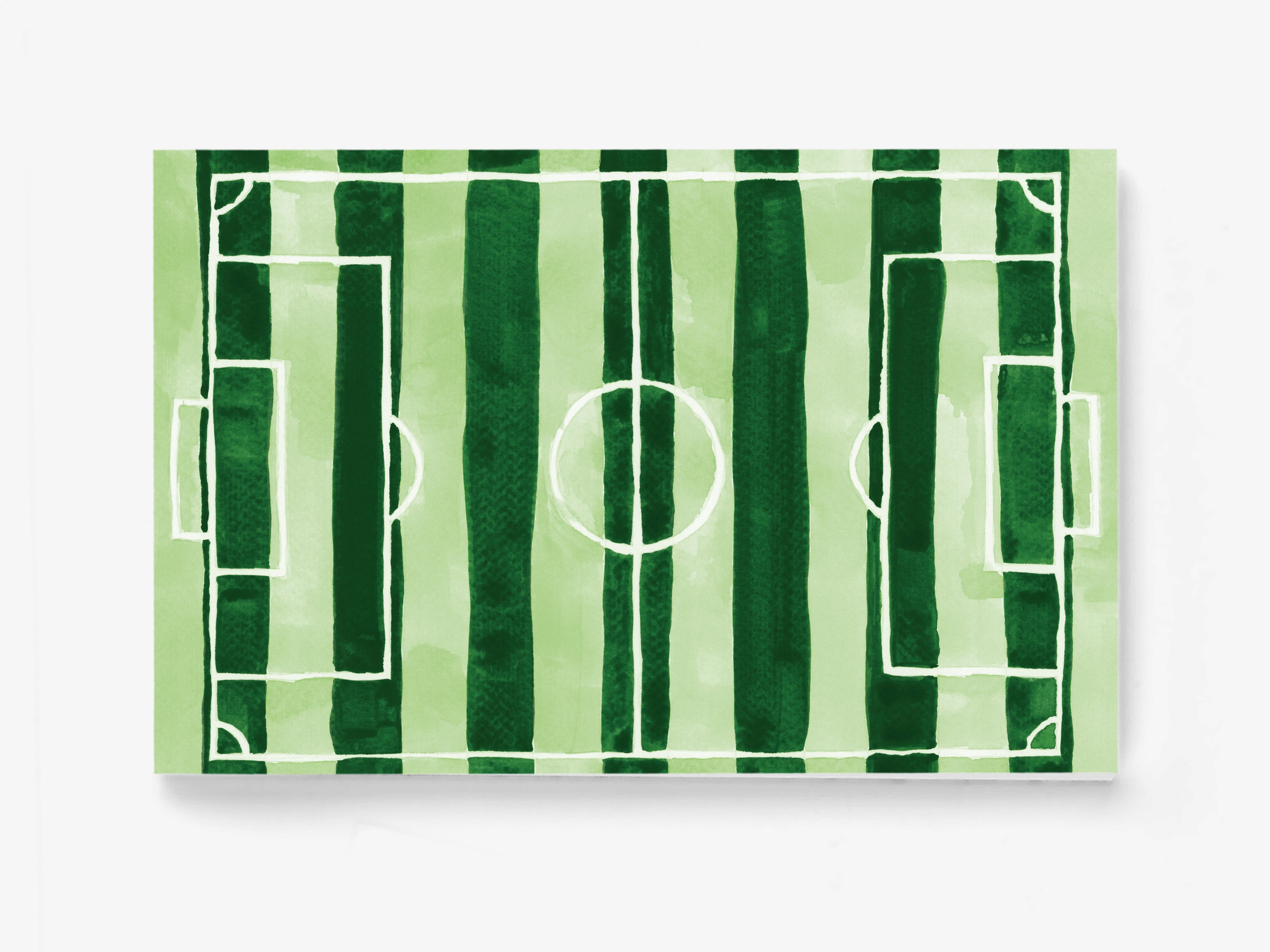 a green and white striped soccer field with white lines marking the boundaries and center circle.