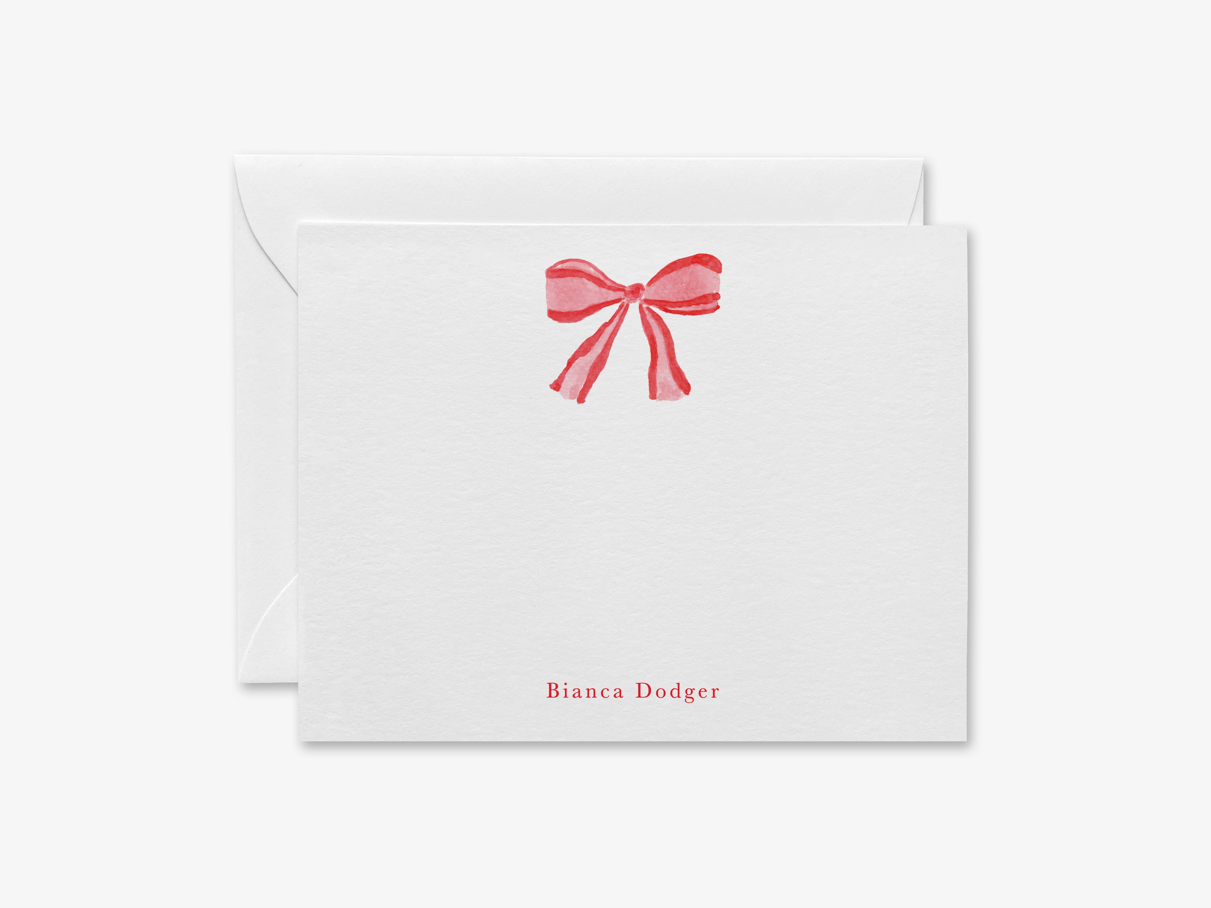 A white envelope with a red bow on the front and the name "Bianca Dodger" printed on it.