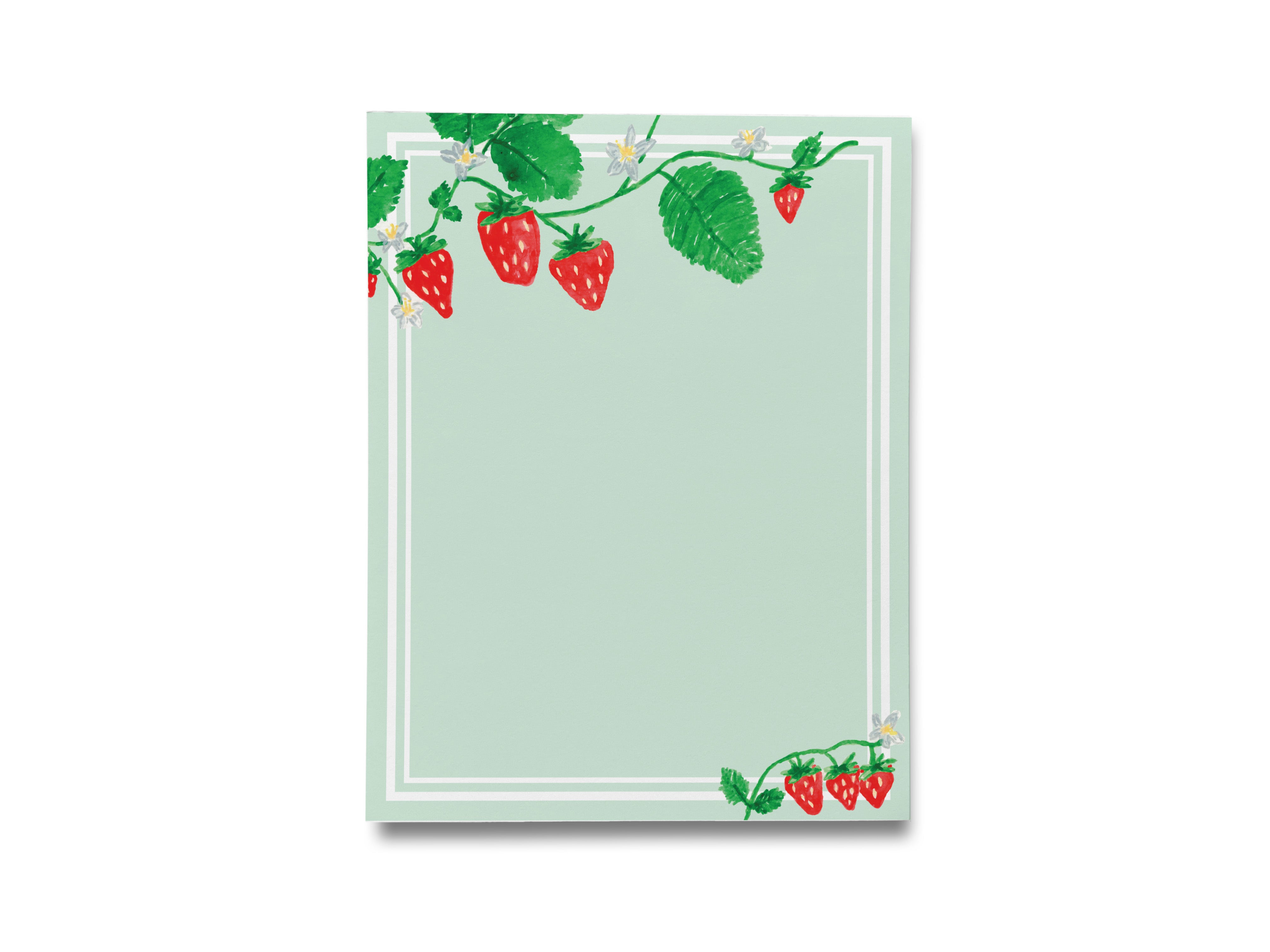 a notepad with strawberries and leaves on it