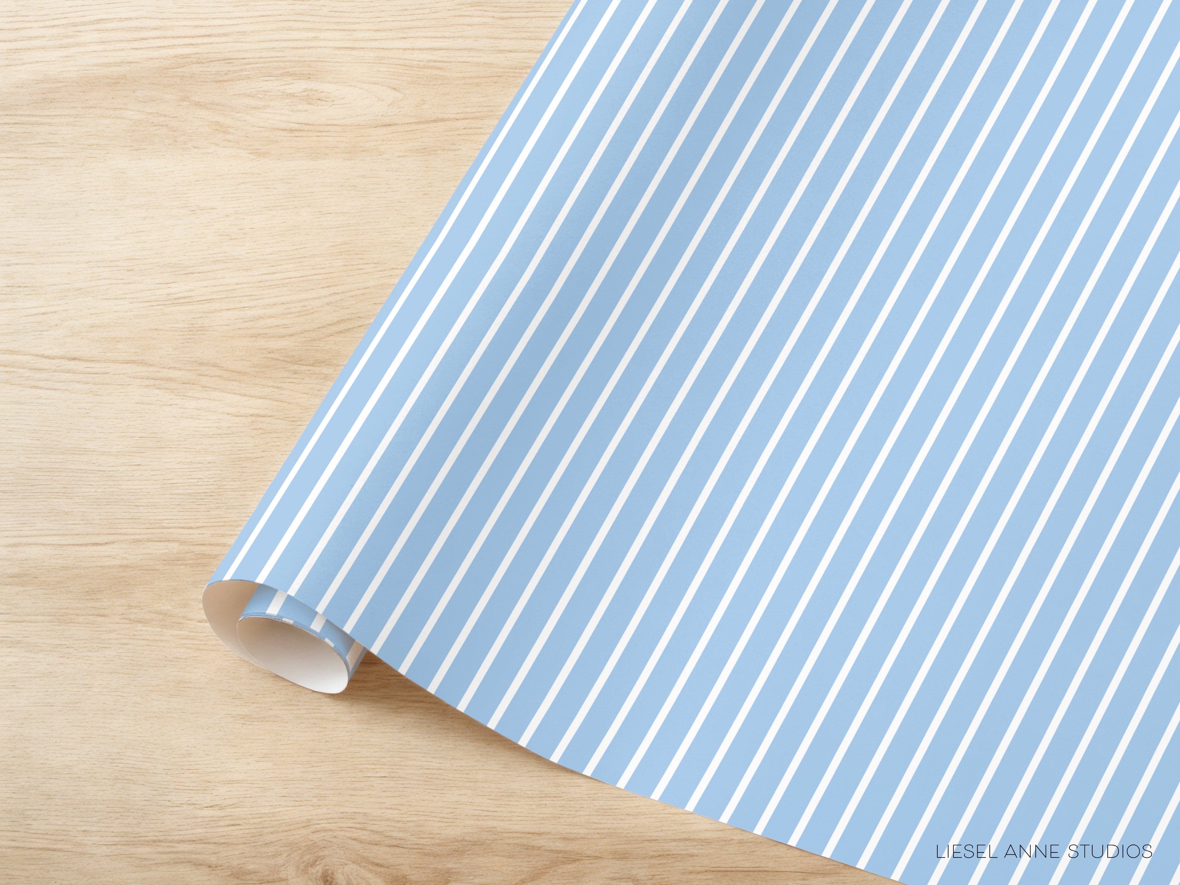 A roll of blue and white striped paper is placed on a wooden surface.