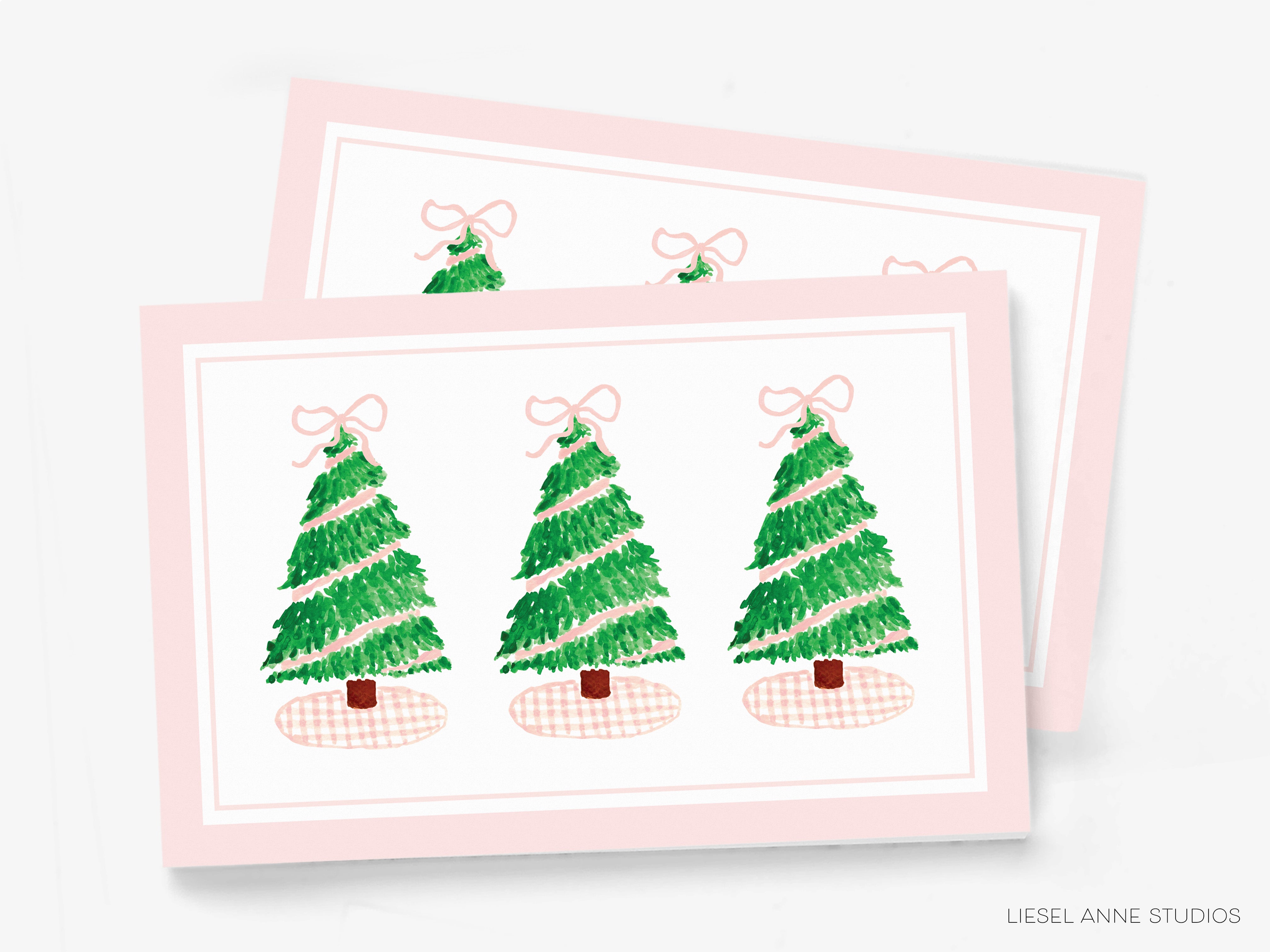 A pink greeting card with three Christmas trees and pink bows on top.