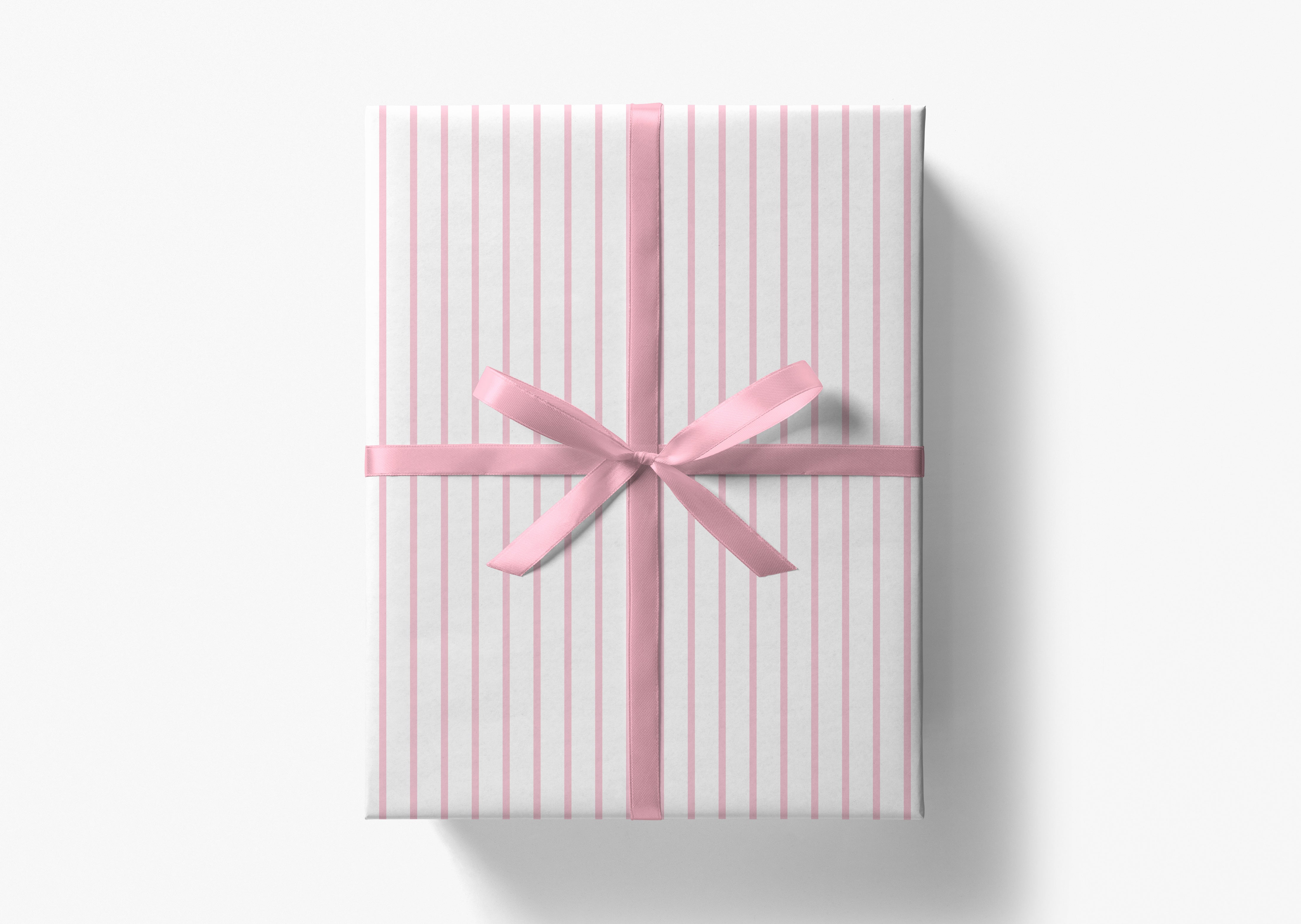 A gift box wrapped in pink and white striped paper with a pink ribbon bow tied around it.