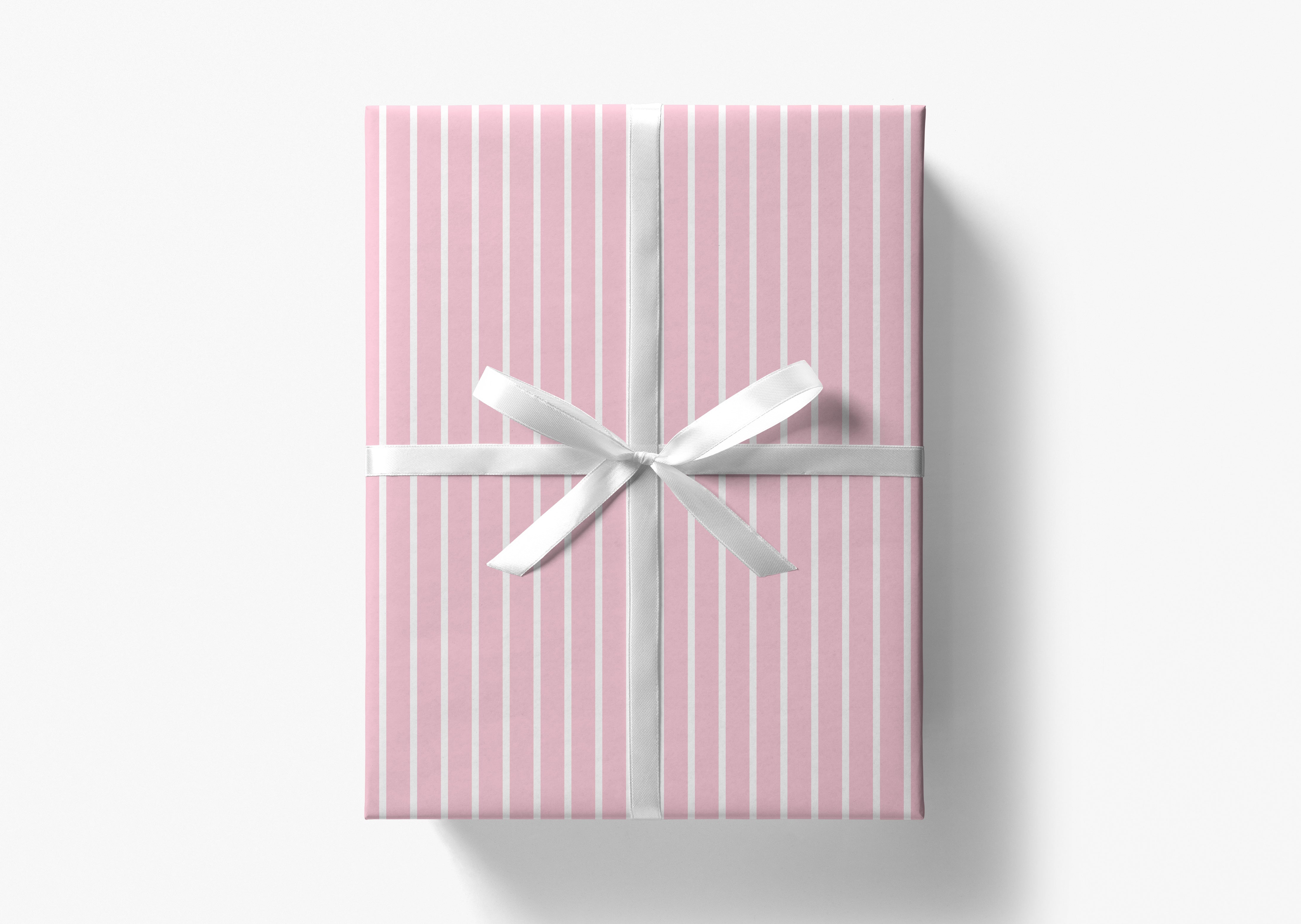 A pink gift box with a white ribbon tied in a bow, placed against a white background.