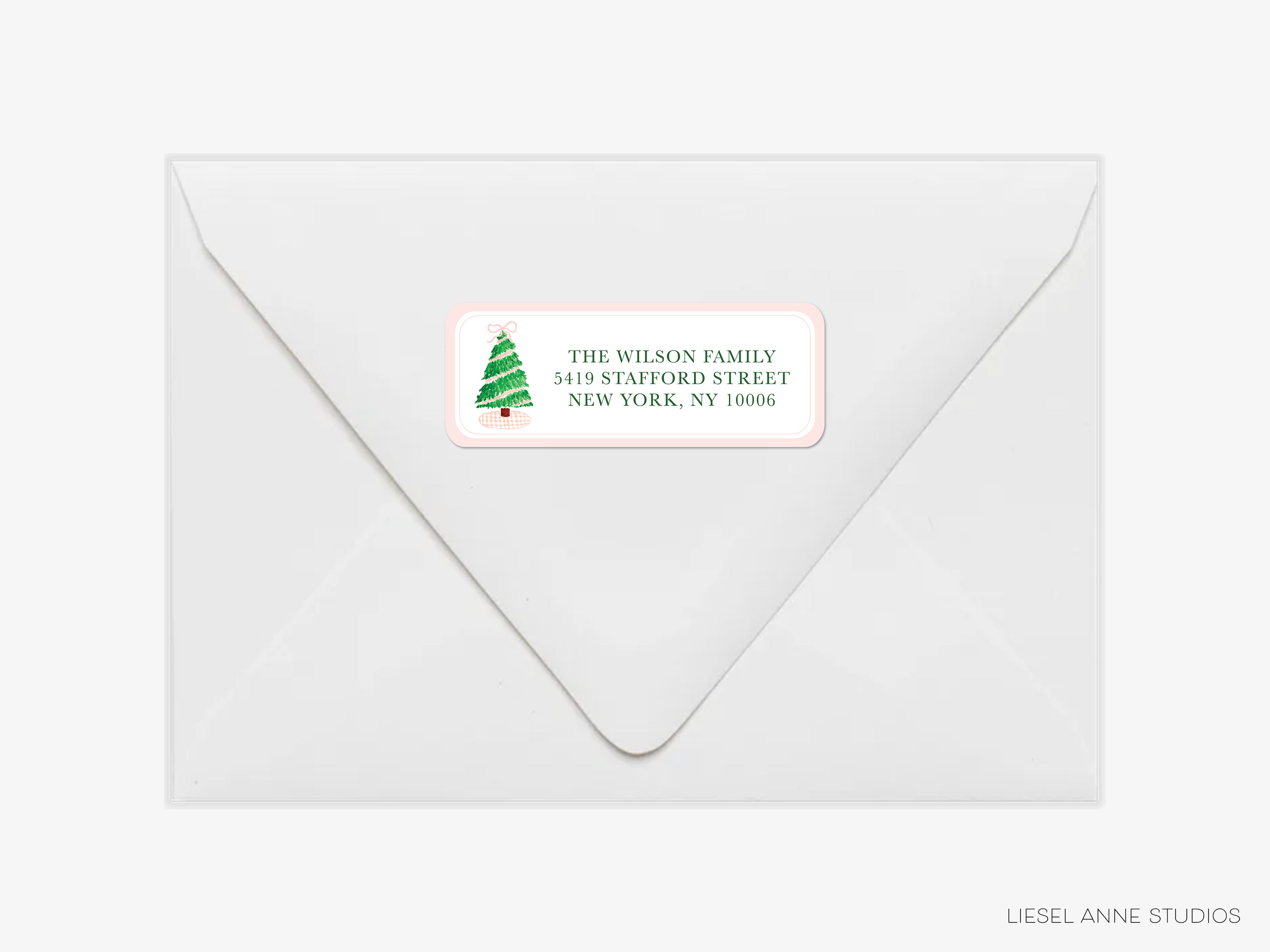 a white envelope with a label on it, which appears to be a Christmas-themed address label.